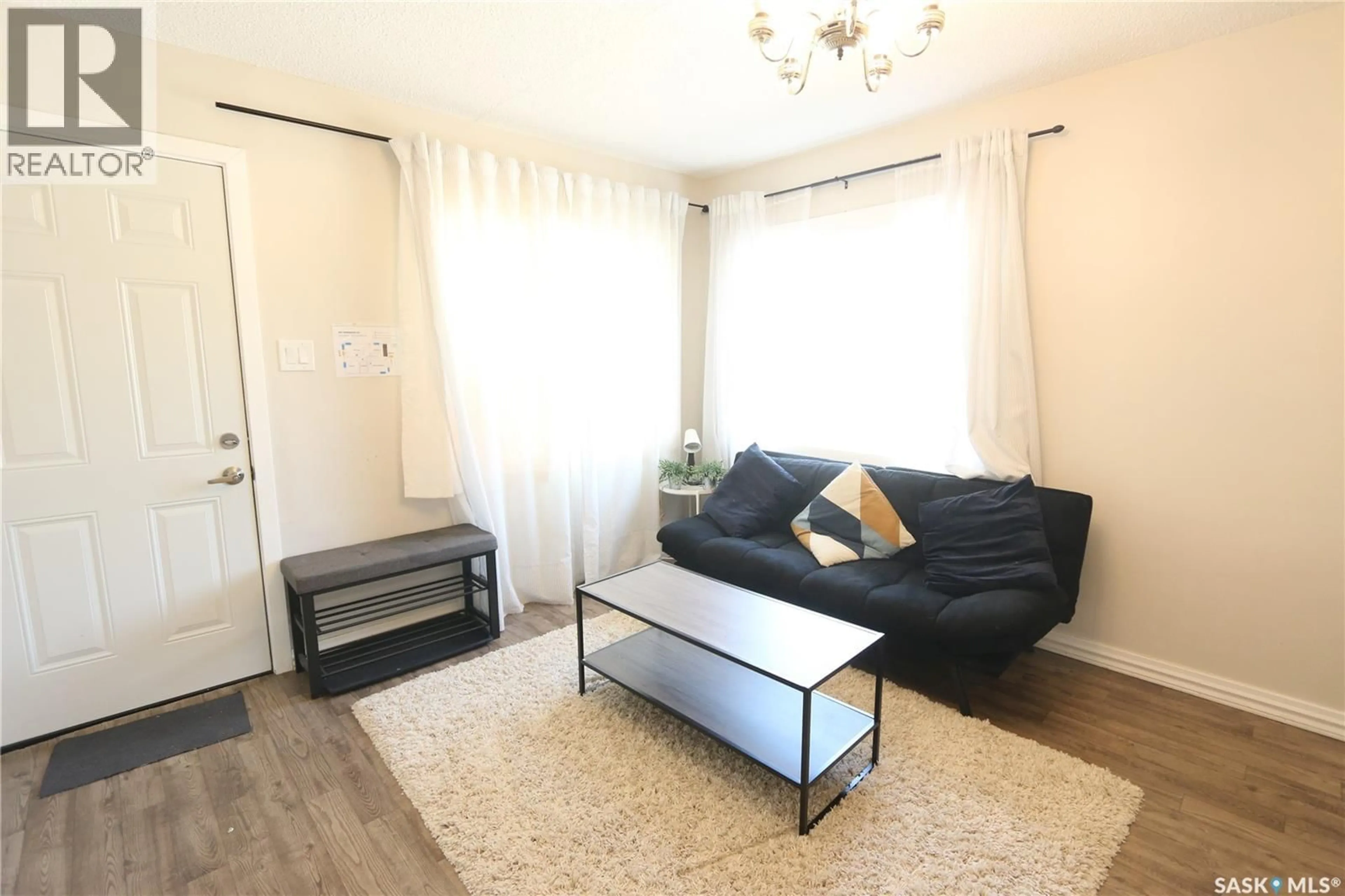 Living room with furniture, wood/laminate floor for 903 ROBINSON STREET, Regina Saskatchewan S4T2M6