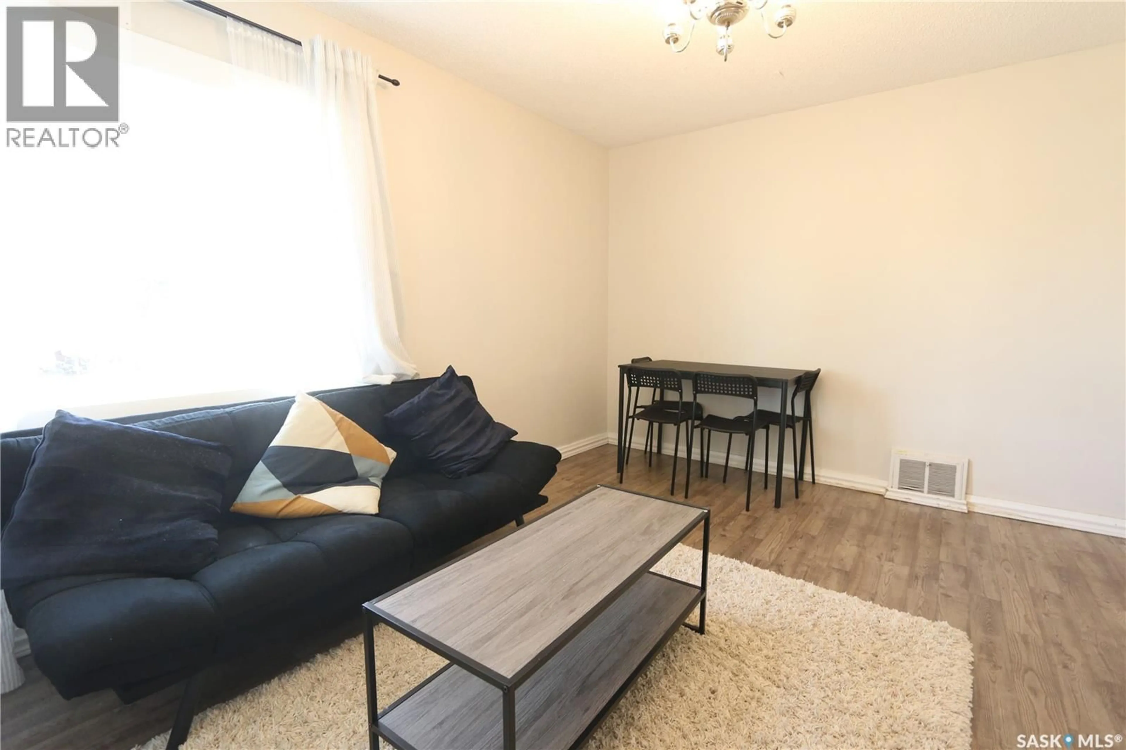 Living room with furniture, wood/laminate floor for 903 ROBINSON STREET, Regina Saskatchewan S4T2M6