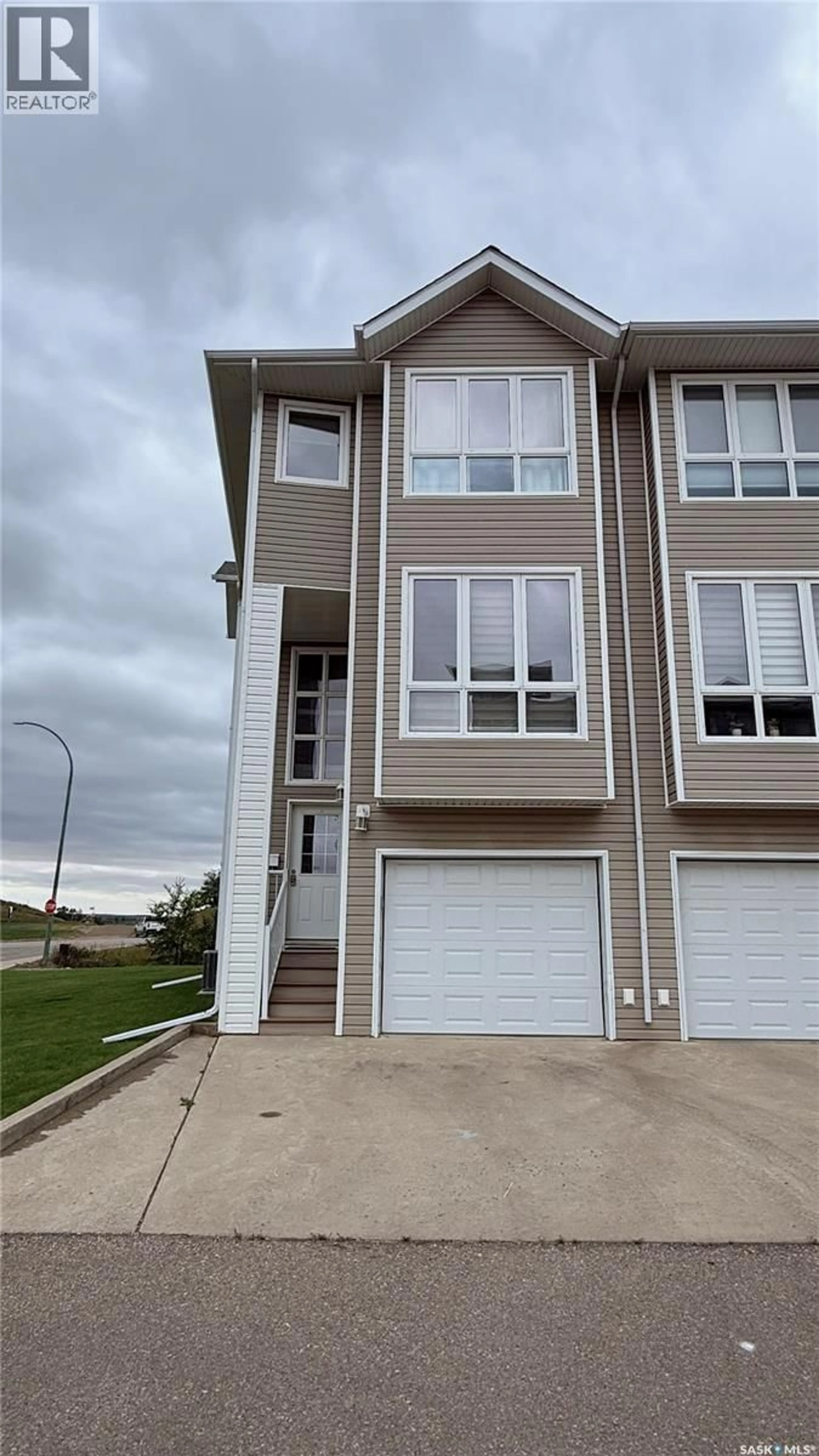 Home with vinyl exterior material, street for 1 697 SUN VALLEY DRIVE, Estevan Saskatchewan S4A2X7