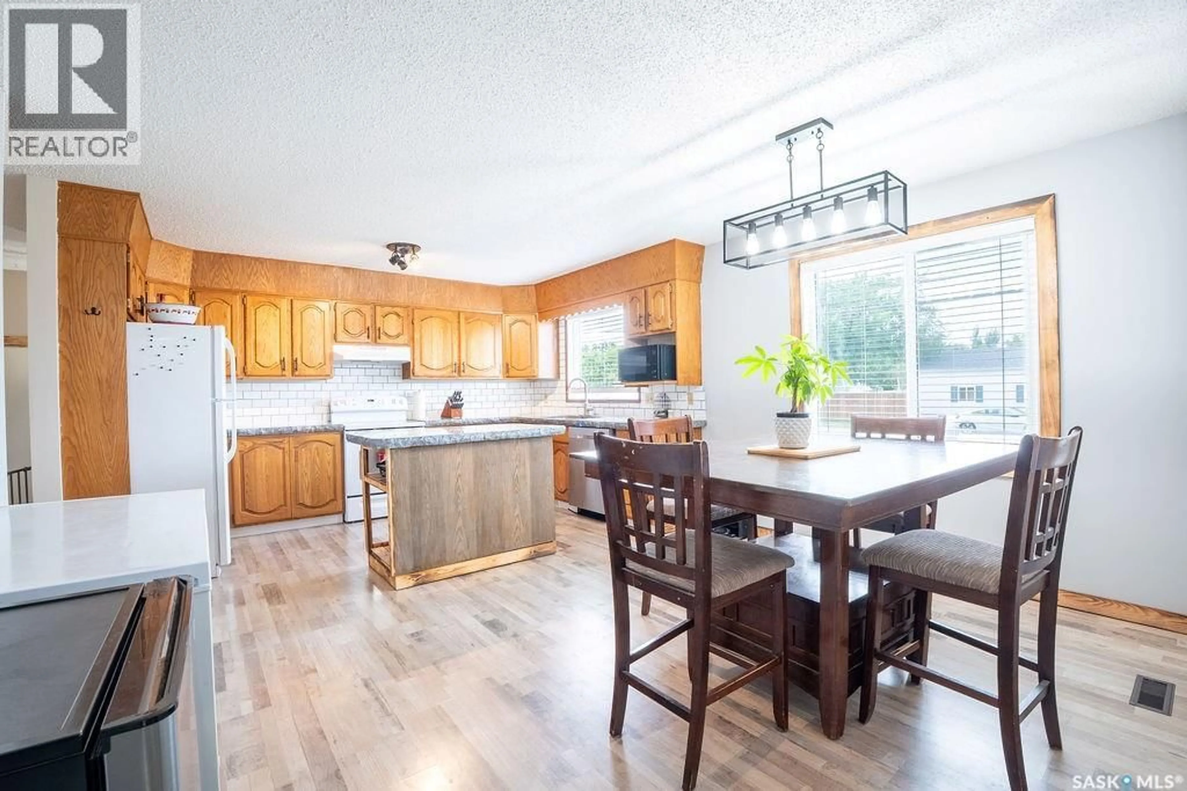 Open concept kitchen, wood/laminate floor for 701 1ST STREET, Hanley Saskatchewan S0G2E0