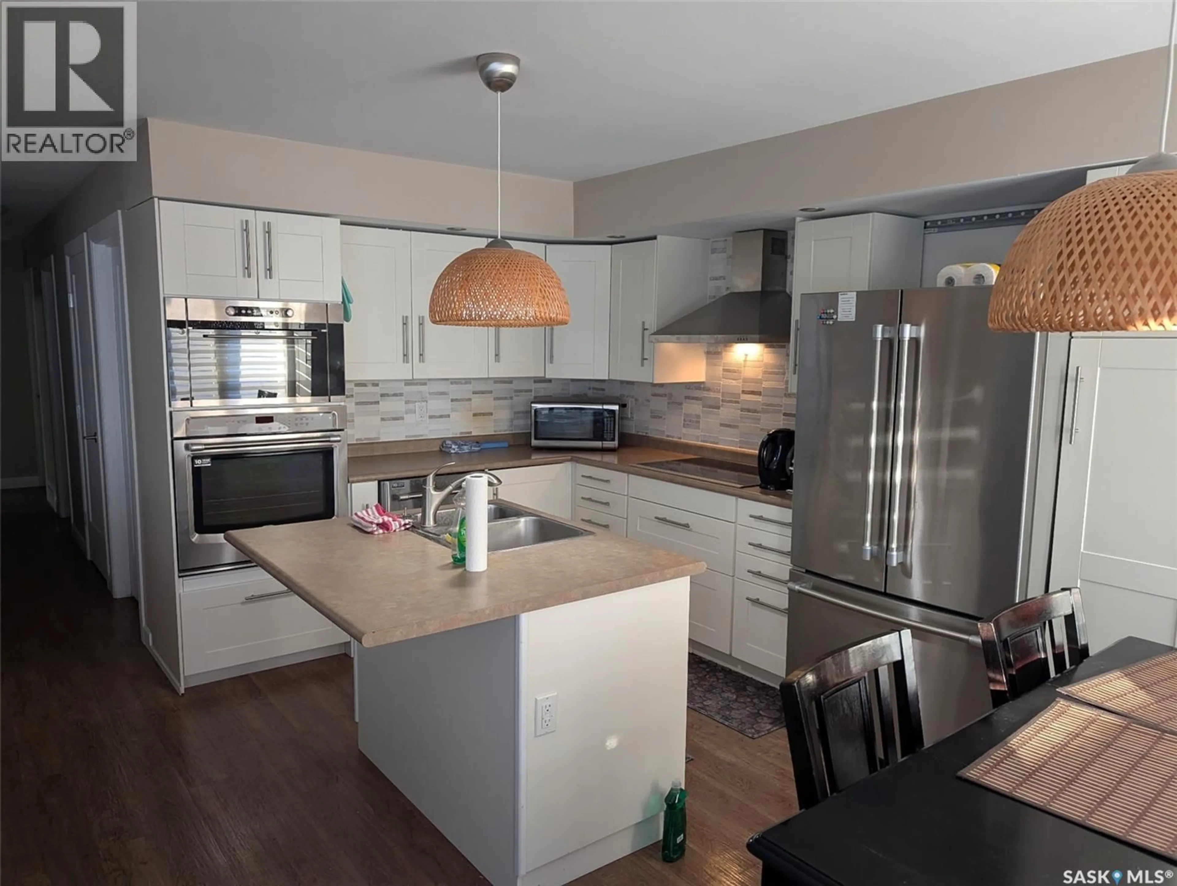 Open concept kitchen, wood/laminate floor for 60 BRADBROOKE DRIVE, Yorkton Saskatchewan S3N2K1