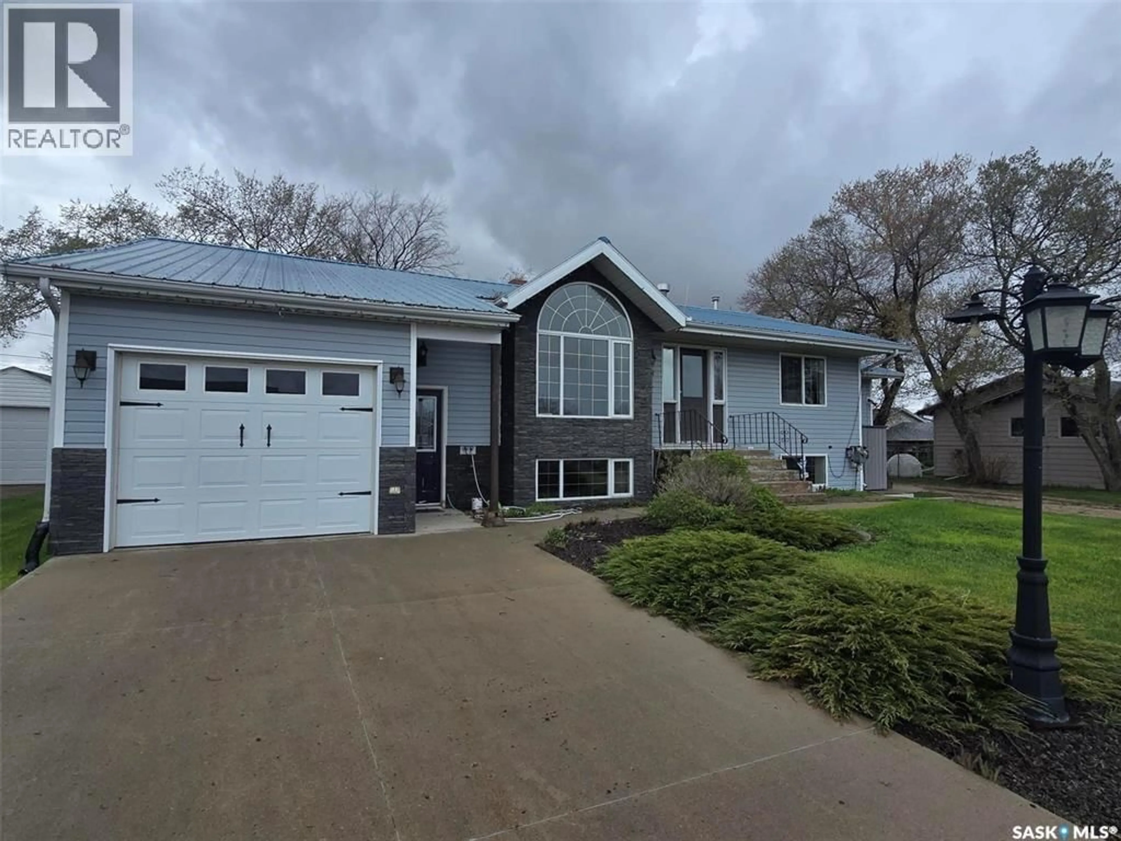 Home with vinyl exterior material, street for 1010 DESMOND STREET, Grenfell Saskatchewan S0G2B0
