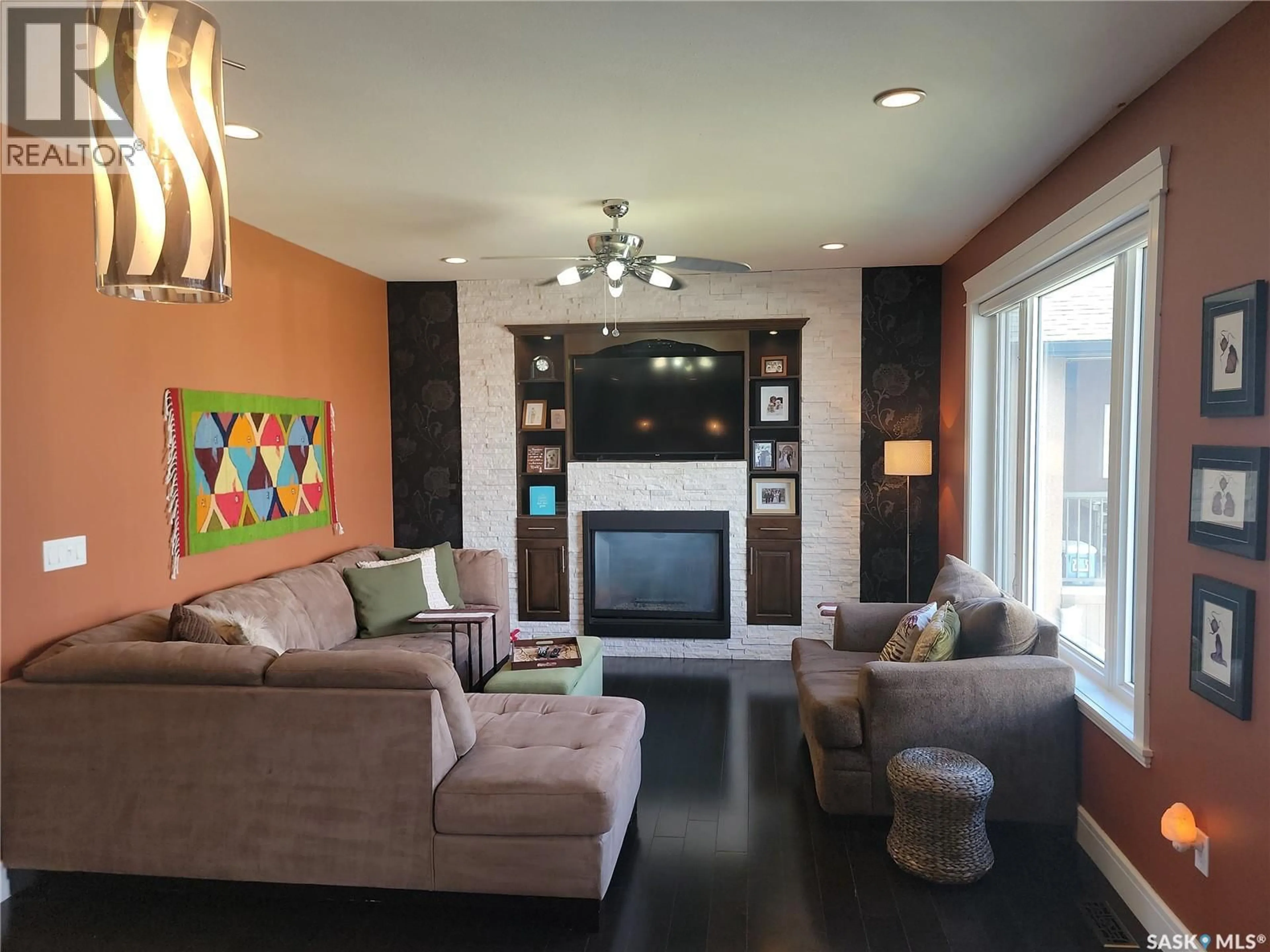 Living room with furniture, wood/laminate floor for 410 NICKLAUS DRIVE, Warman Saskatchewan S0K4S1