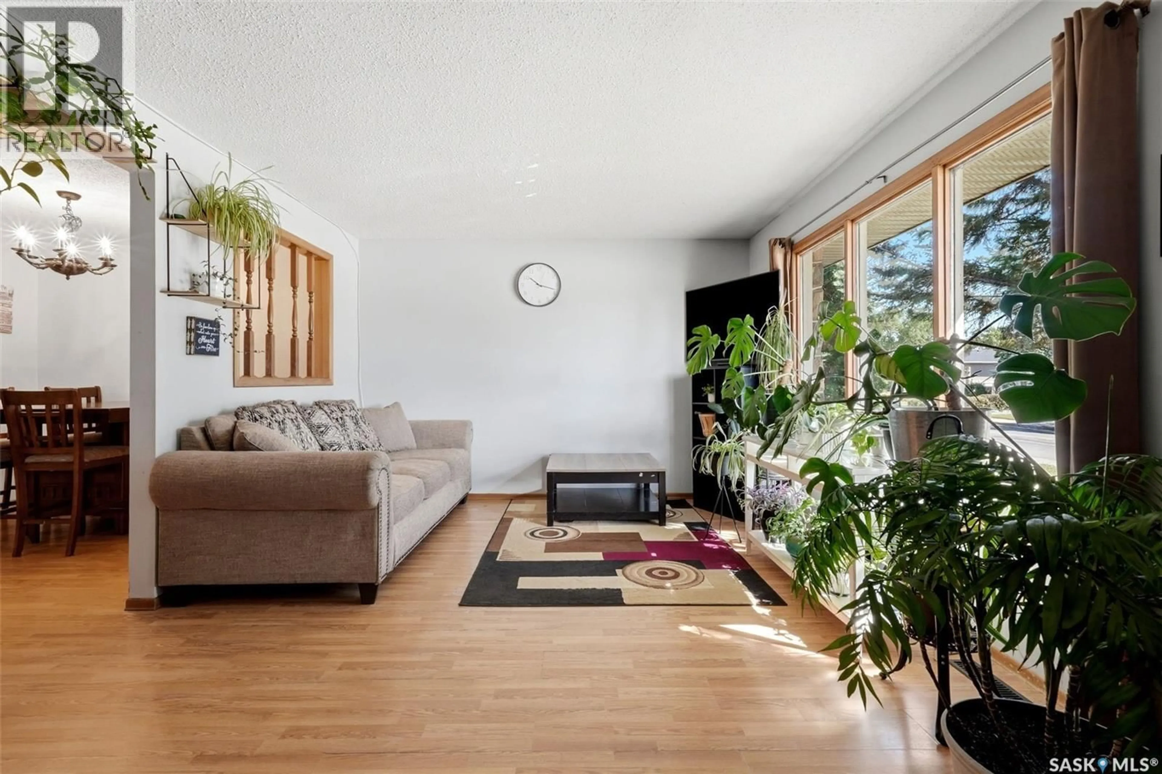 Living room with furniture, wood/laminate floor for 1210-1212 DEWDNEY AVENUE, Regina Saskatchewan S4N0E3