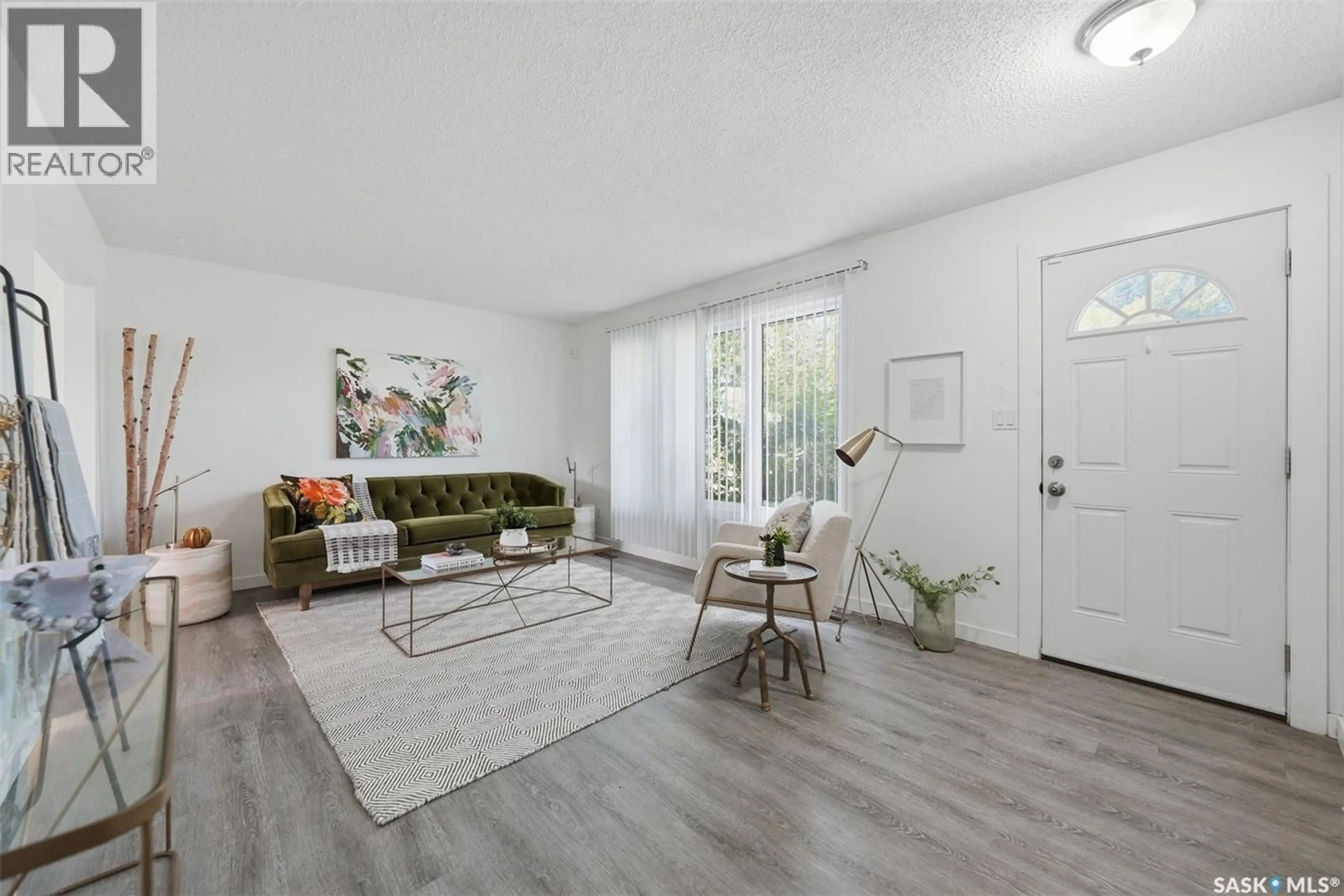 Living room with furniture, wood/laminate floor for 814 STEEVES AVENUE, Saskatoon Saskatchewan S7L5N1