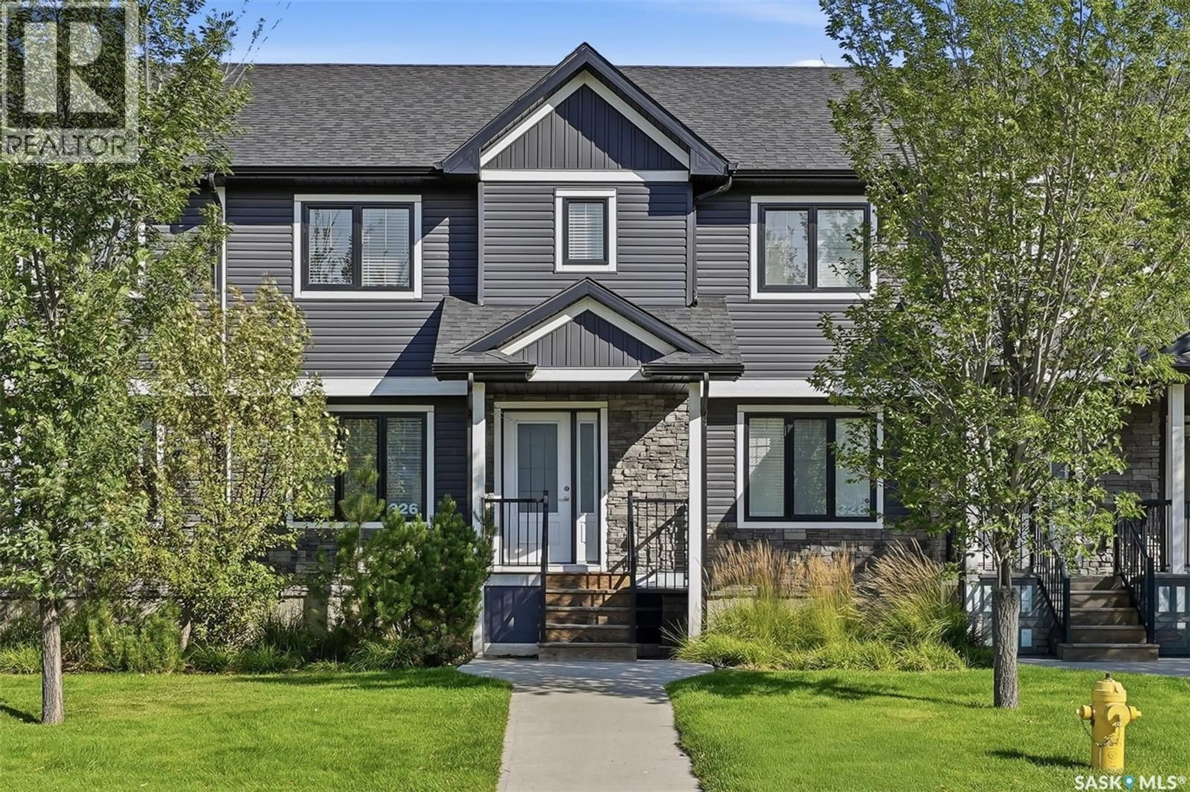 Home with vinyl exterior material, street for 326 MANINGAS BEND, Saskatoon Saskatchewan S7W0V8