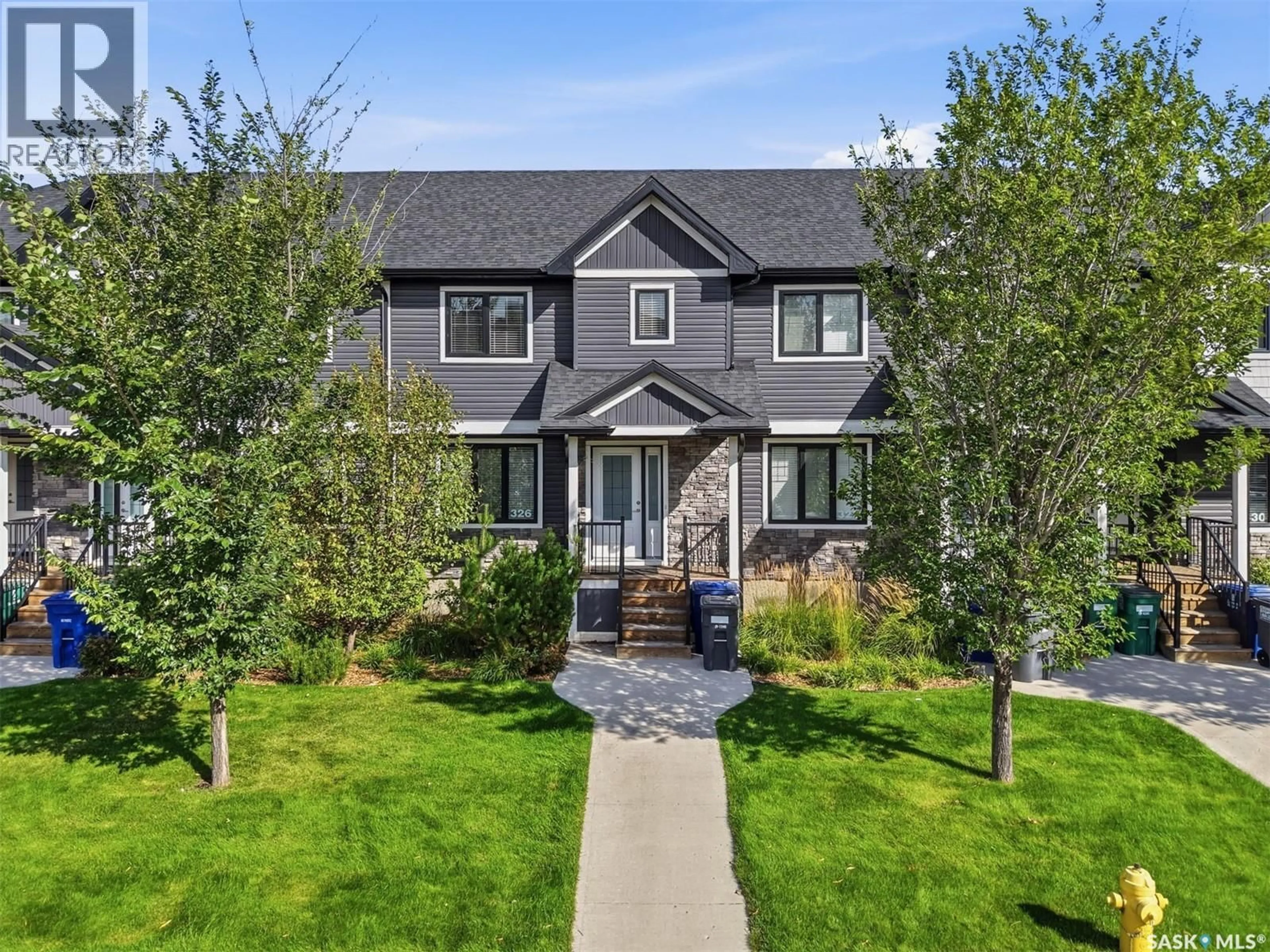 Home with vinyl exterior material, street for 326 MANINGAS BEND, Saskatoon Saskatchewan S7W0V8
