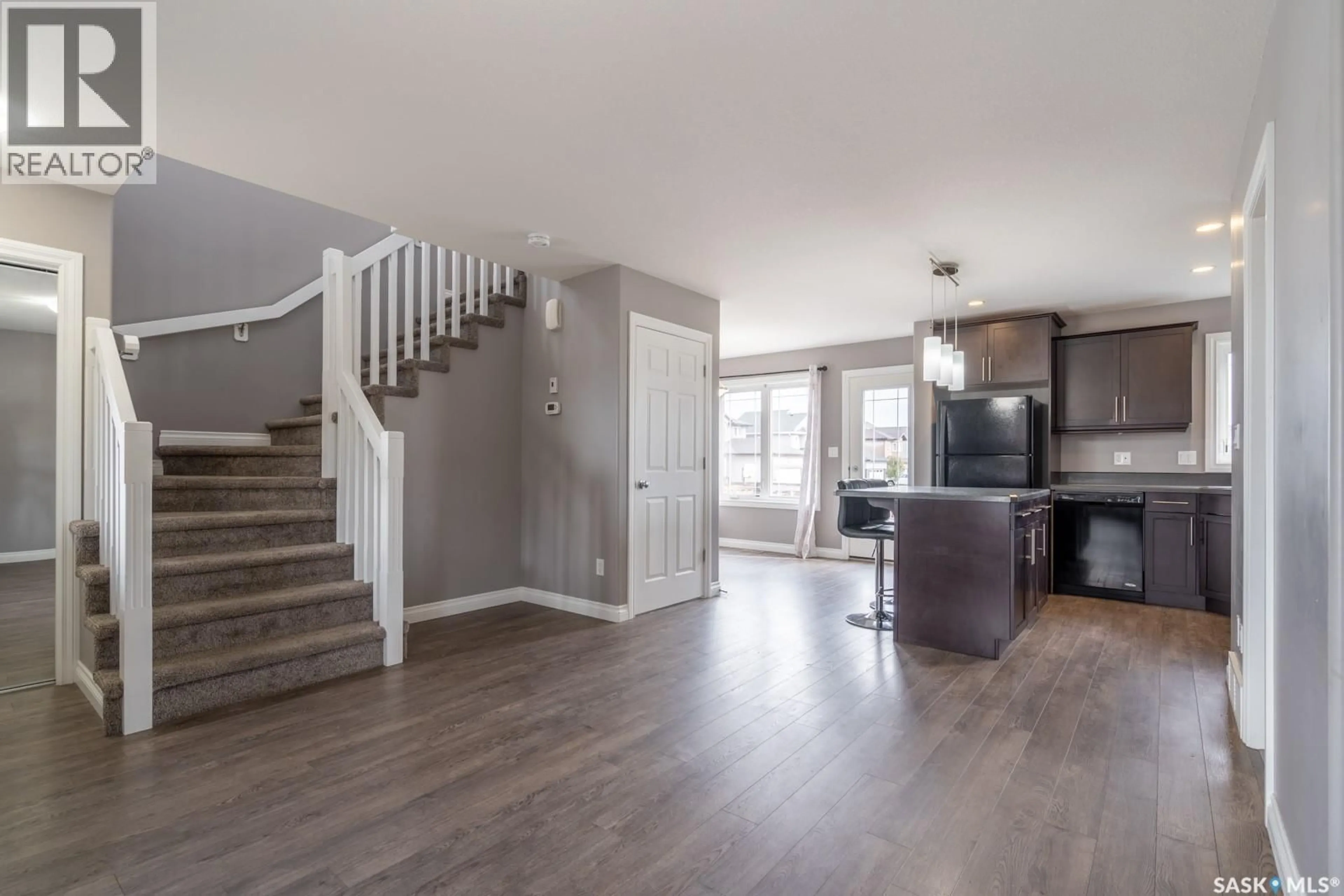 Open concept kitchen, wood/laminate floor for 8701 ARCHER LANE, Regina Saskatchewan S4Y1A3