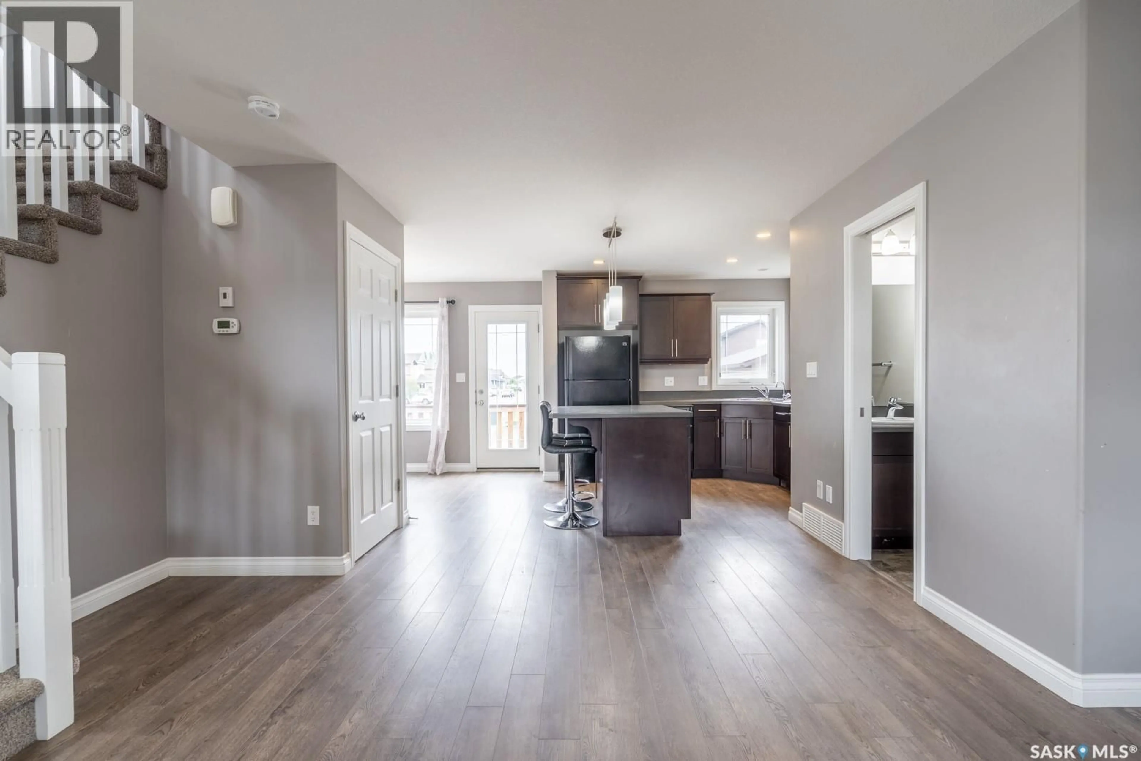 Open concept kitchen, wood/laminate floor for 8701 ARCHER LANE, Regina Saskatchewan S4Y1A3