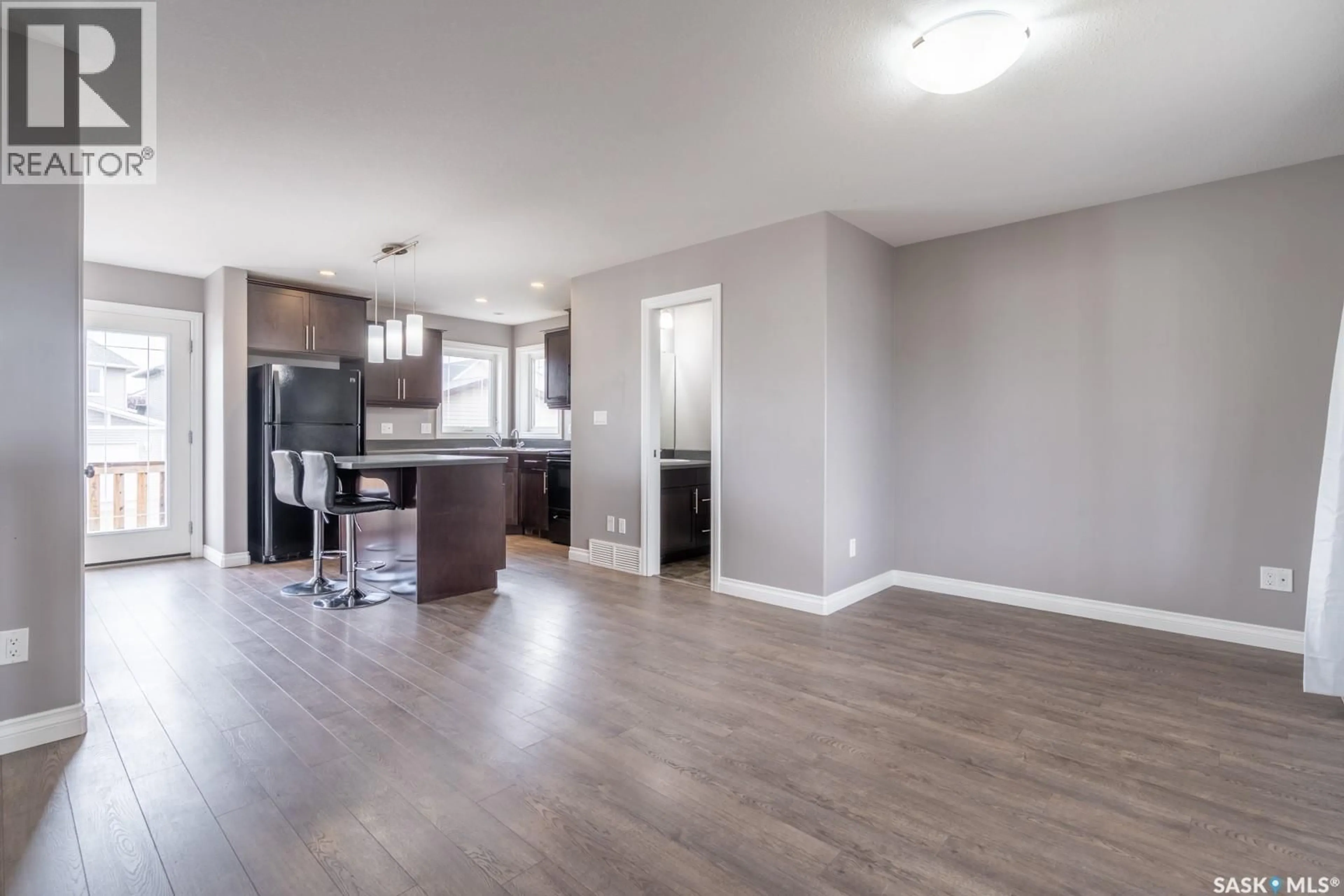 Open concept kitchen, wood/laminate floor for 8701 ARCHER LANE, Regina Saskatchewan S4Y1A3