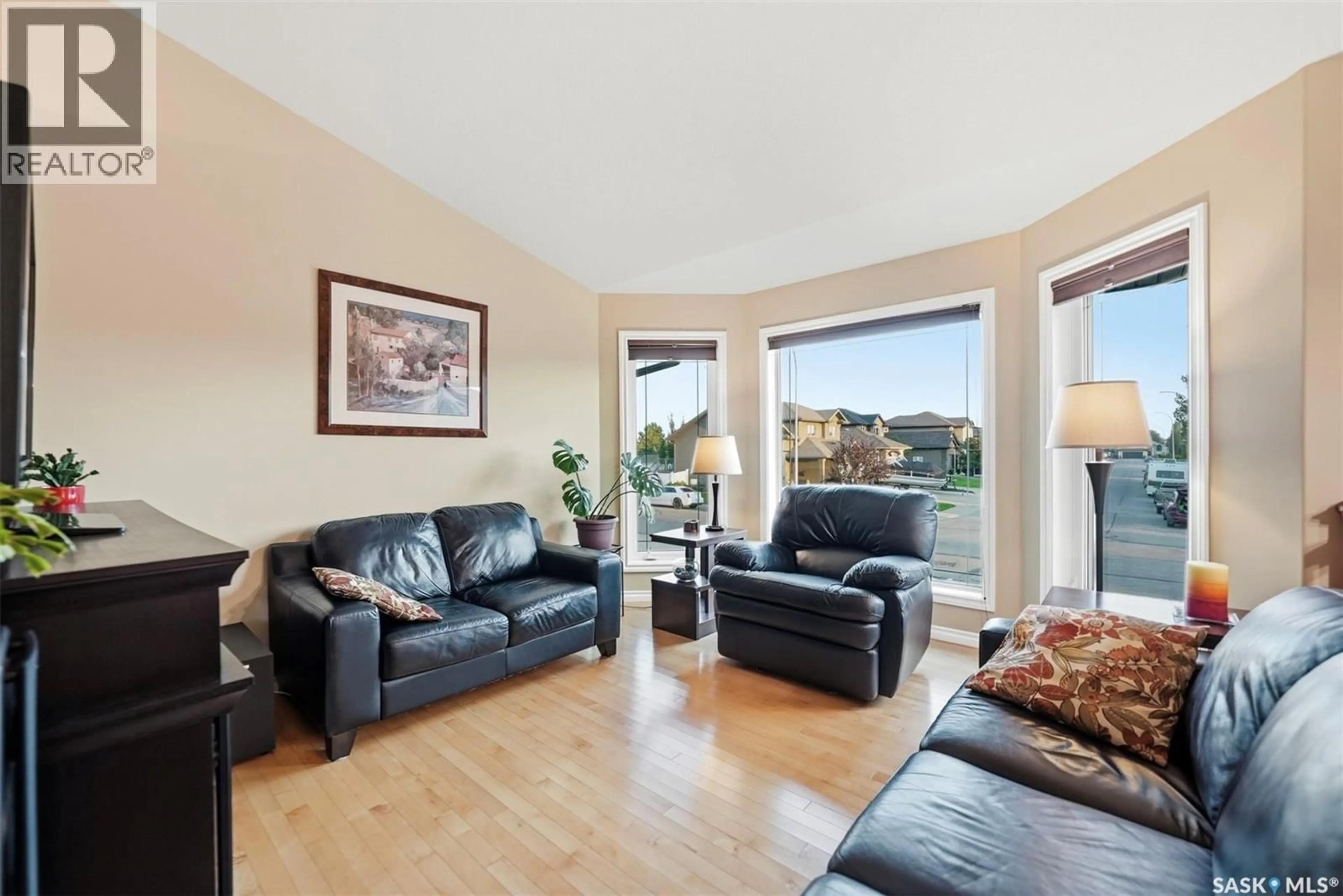 Living room with furniture, wood/laminate floor for 220 FLOYD COURT, Warman Saskatchewan S0K4S1