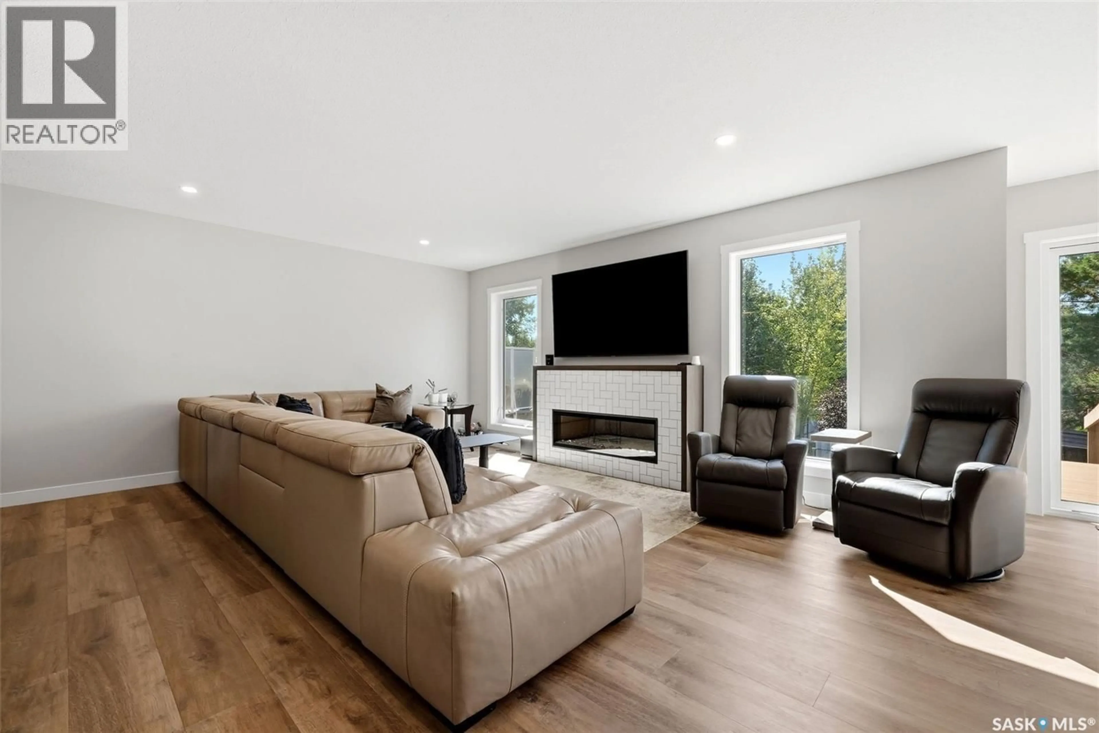 Living room with furniture, wood/laminate floor for 715 3RD AVENUE, Pilot Butte Saskatchewan S0G3Z0