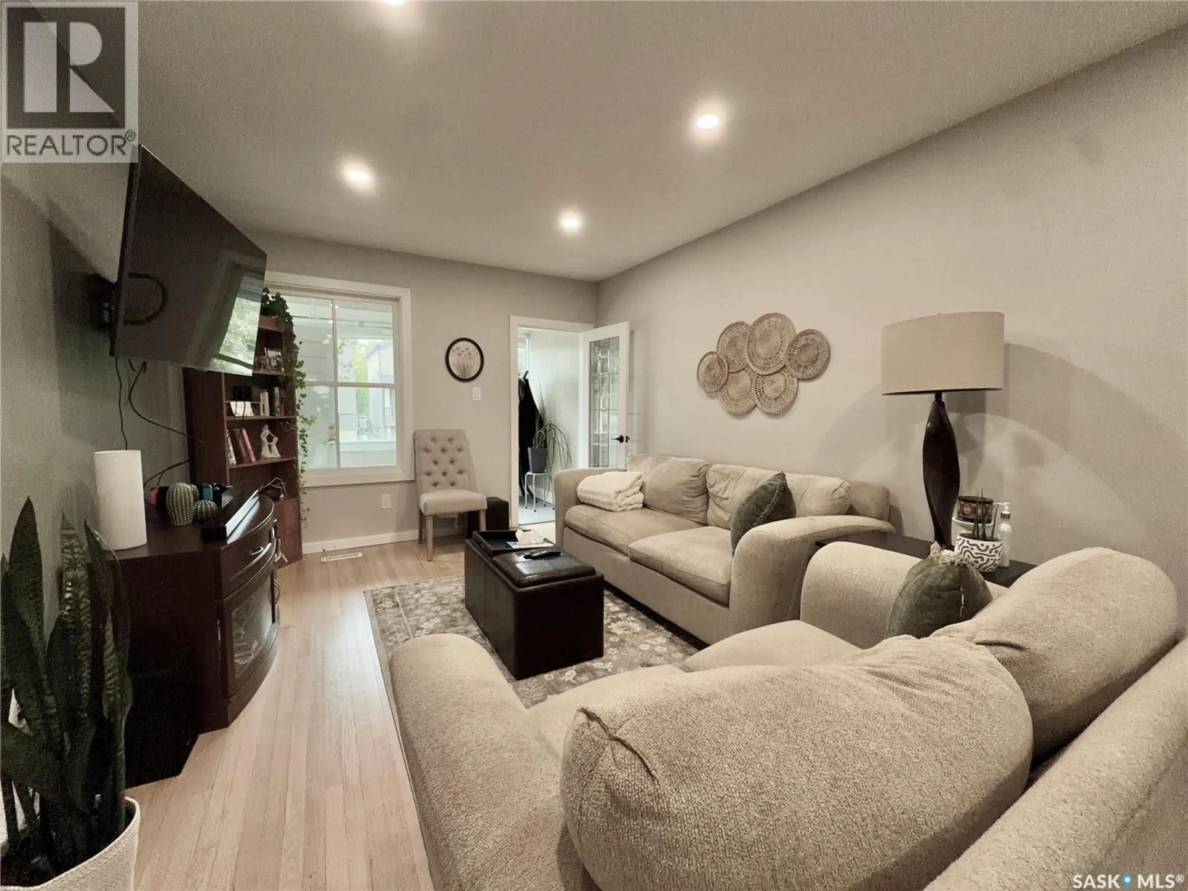 Living room with furniture, wood/laminate floor for 1449 MCINTOSH STREET, Regina Saskatchewan S4T5C4