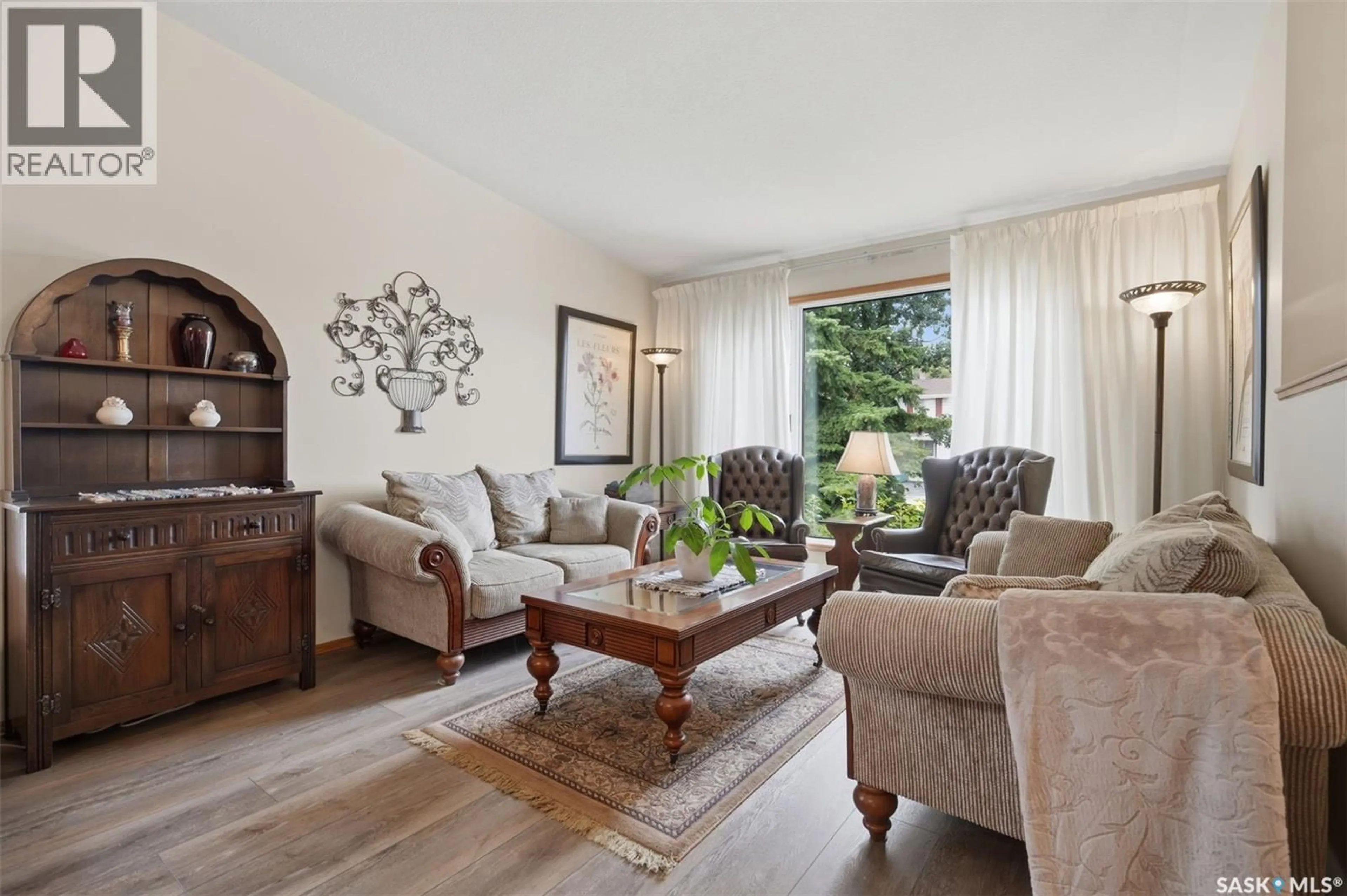 Living room with furniture, wood/laminate floor for 504 3RD STREET, Watrous Saskatchewan S0K4T0