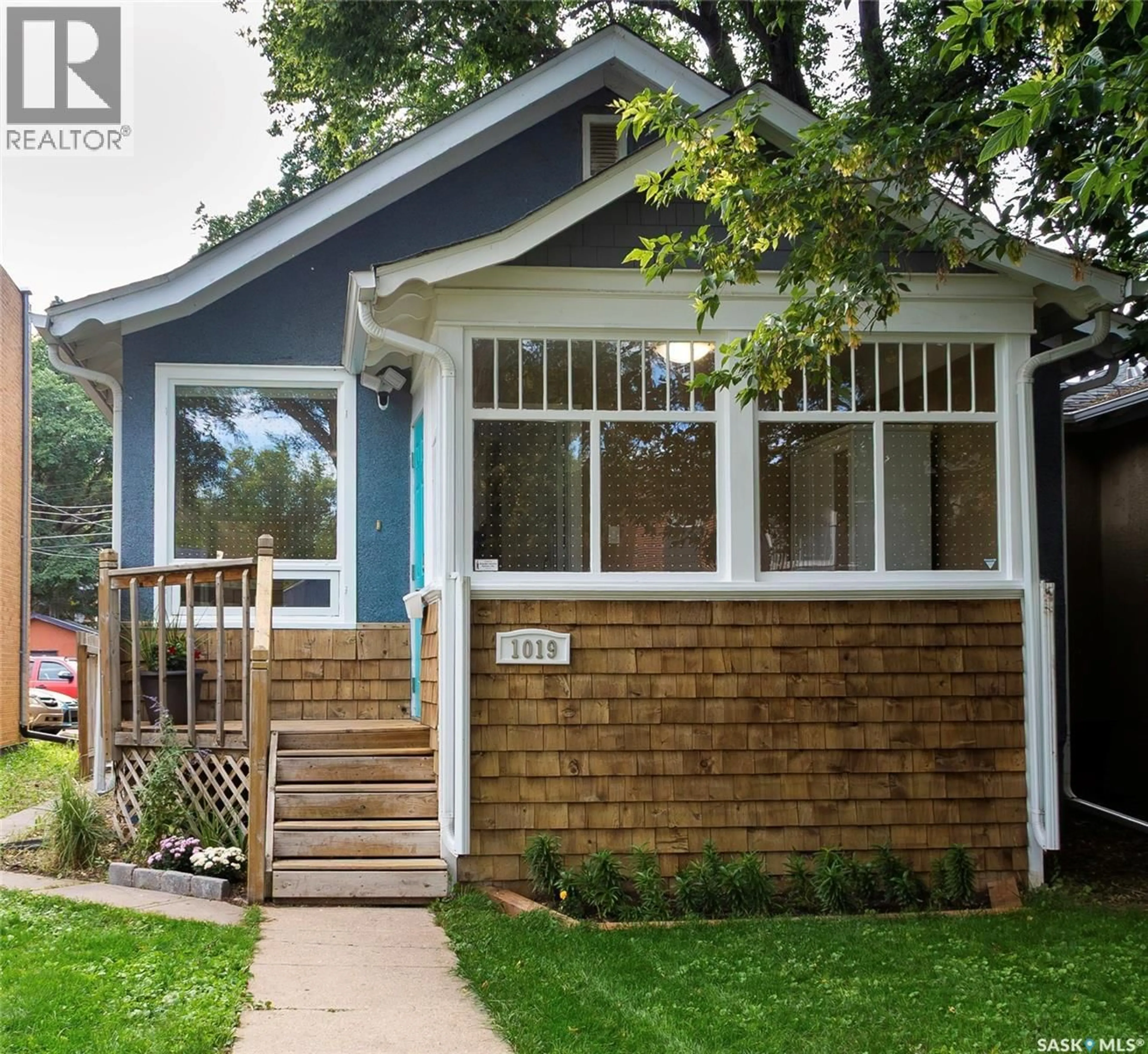 Home with vinyl exterior material, street for 1019 C AVENUE, Saskatoon Saskatchewan S7L1K1