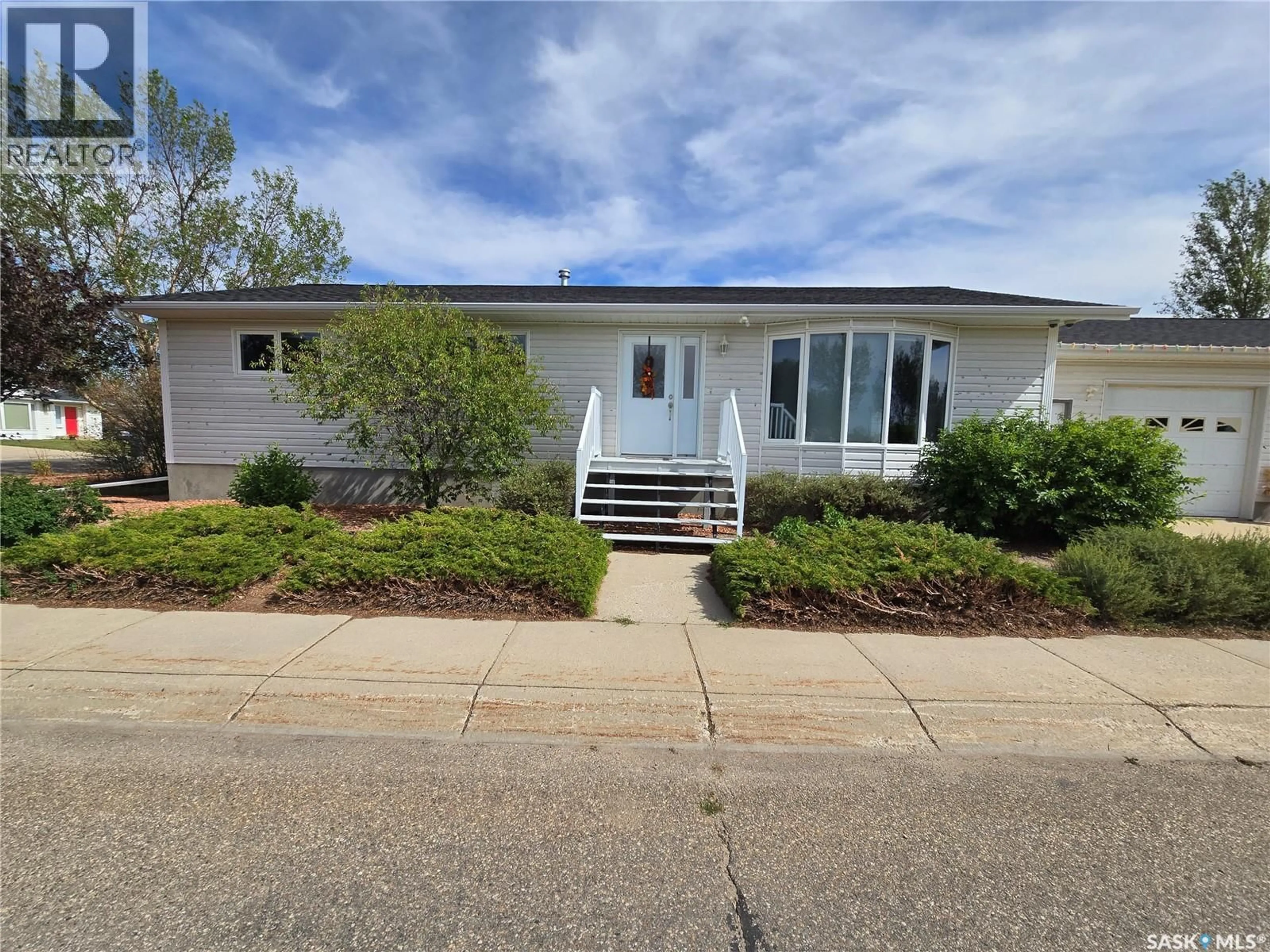Home with vinyl exterior material, street for 523 MAXWELL DRIVE, Swift Current Saskatchewan S9H4Z6