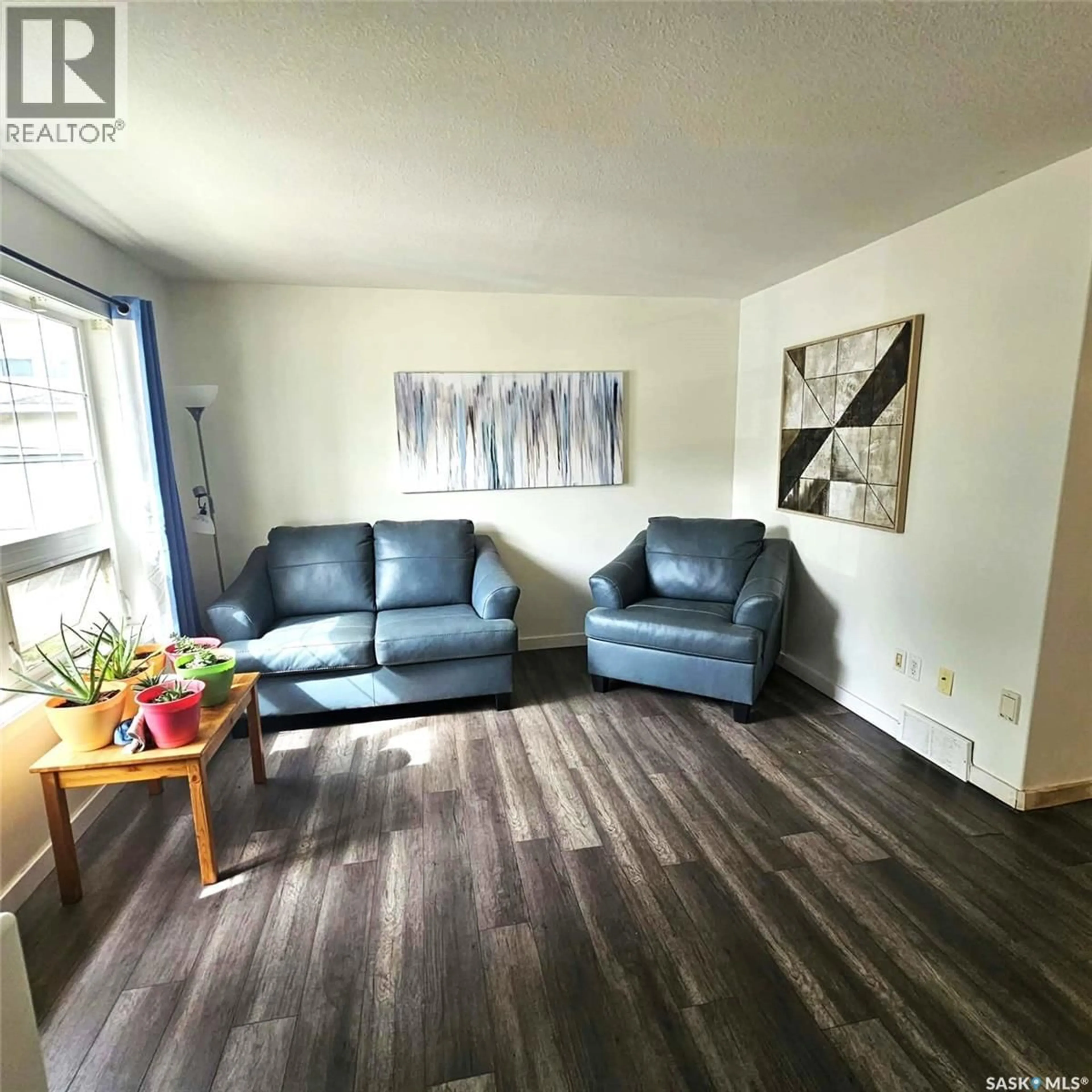 Living room with furniture, wood/laminate floor for 46 - 4901 CHILD AVENUE, Regina Saskatchewan S4X4P1