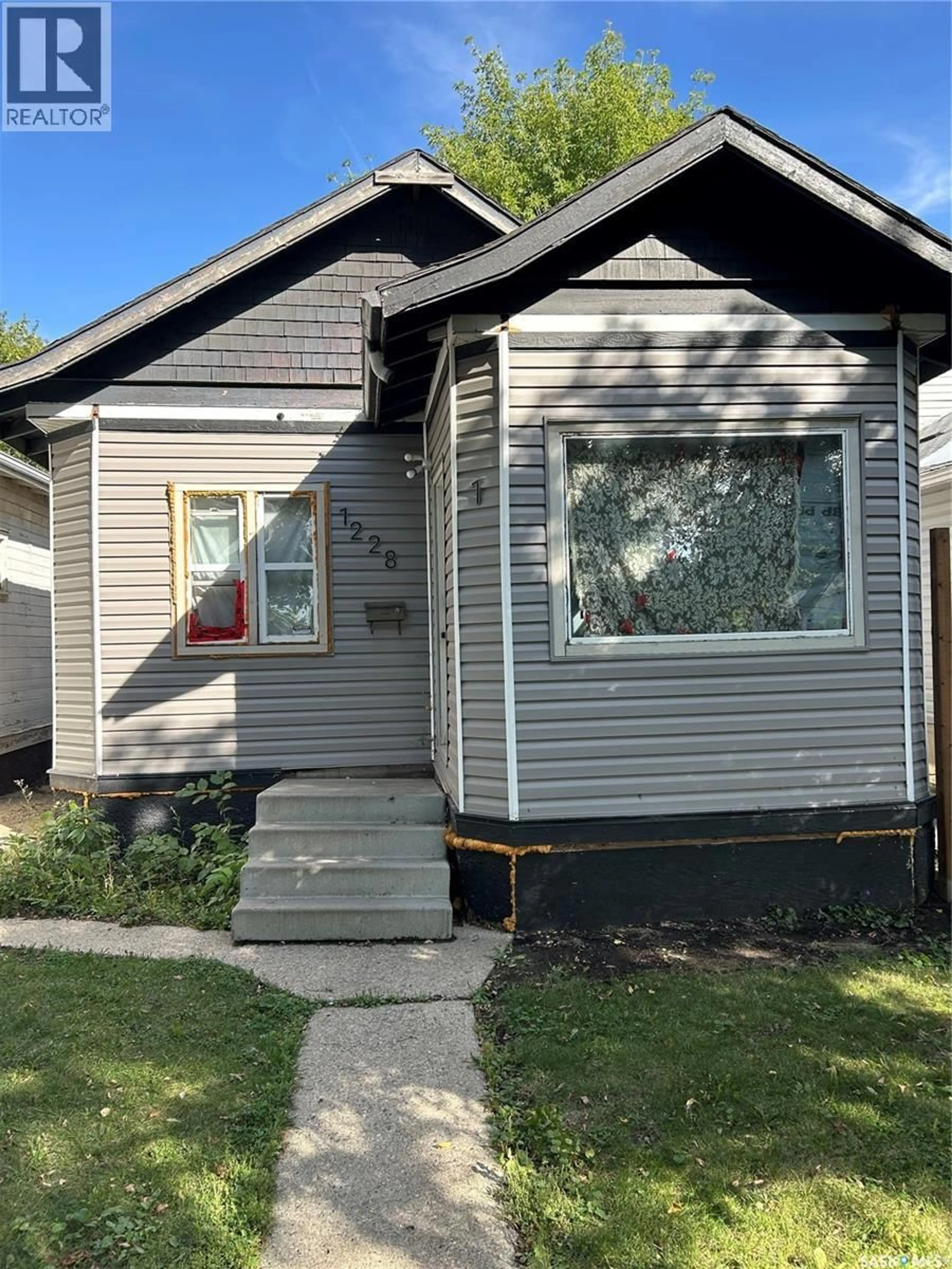 Home with vinyl exterior material, street for 1228 G AVENUE, Saskatoon Saskatchewan S7L2A4