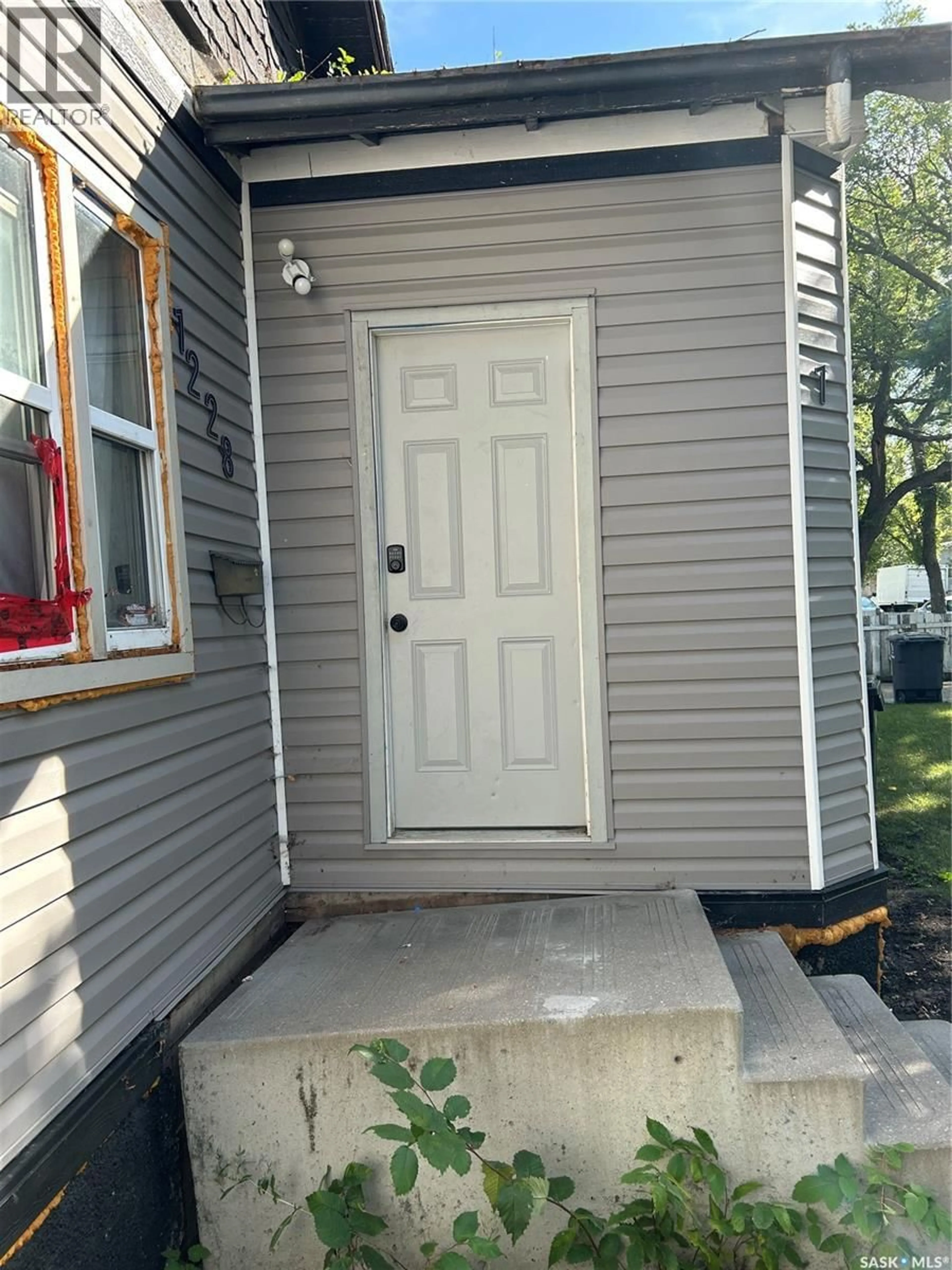Home with vinyl exterior material, street for 1228 G AVENUE, Saskatoon Saskatchewan S7L2A4