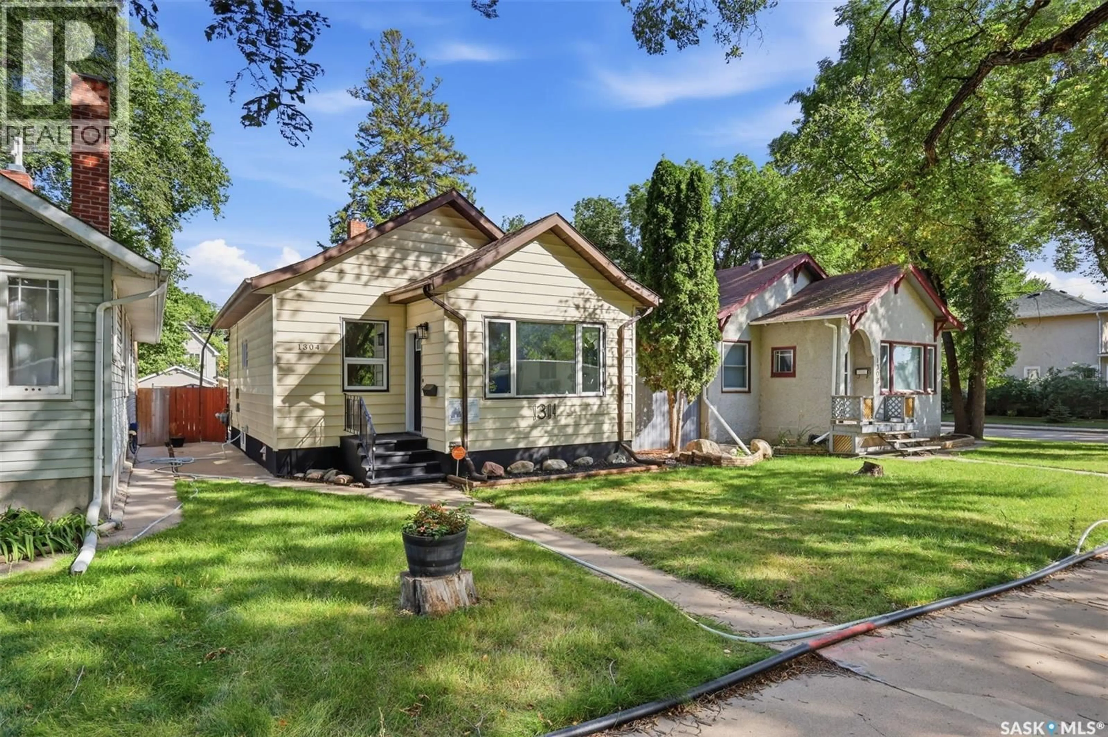 Home with vinyl exterior material, street for 1304 C AVENUE, Saskatoon Saskatchewan S7L1K8