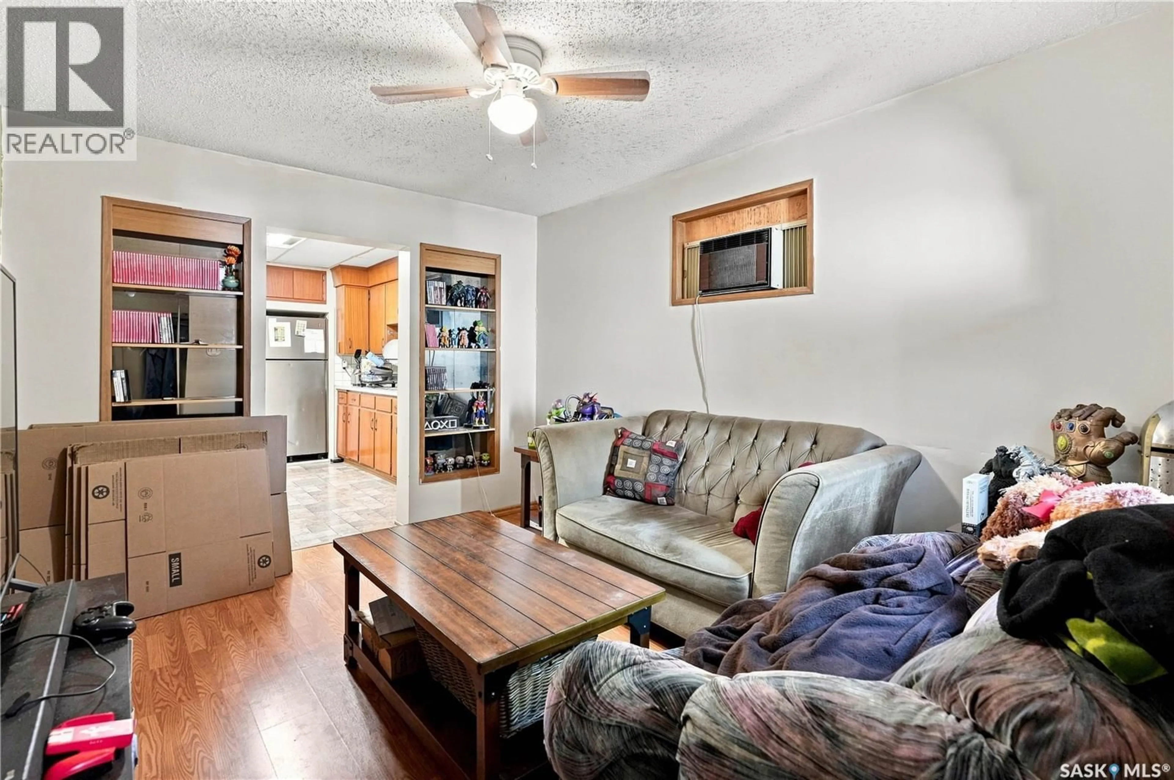 Living room with furniture, wood/laminate floor for 1425 MCINTOSH STREET, Regina Saskatchewan S4T5C4