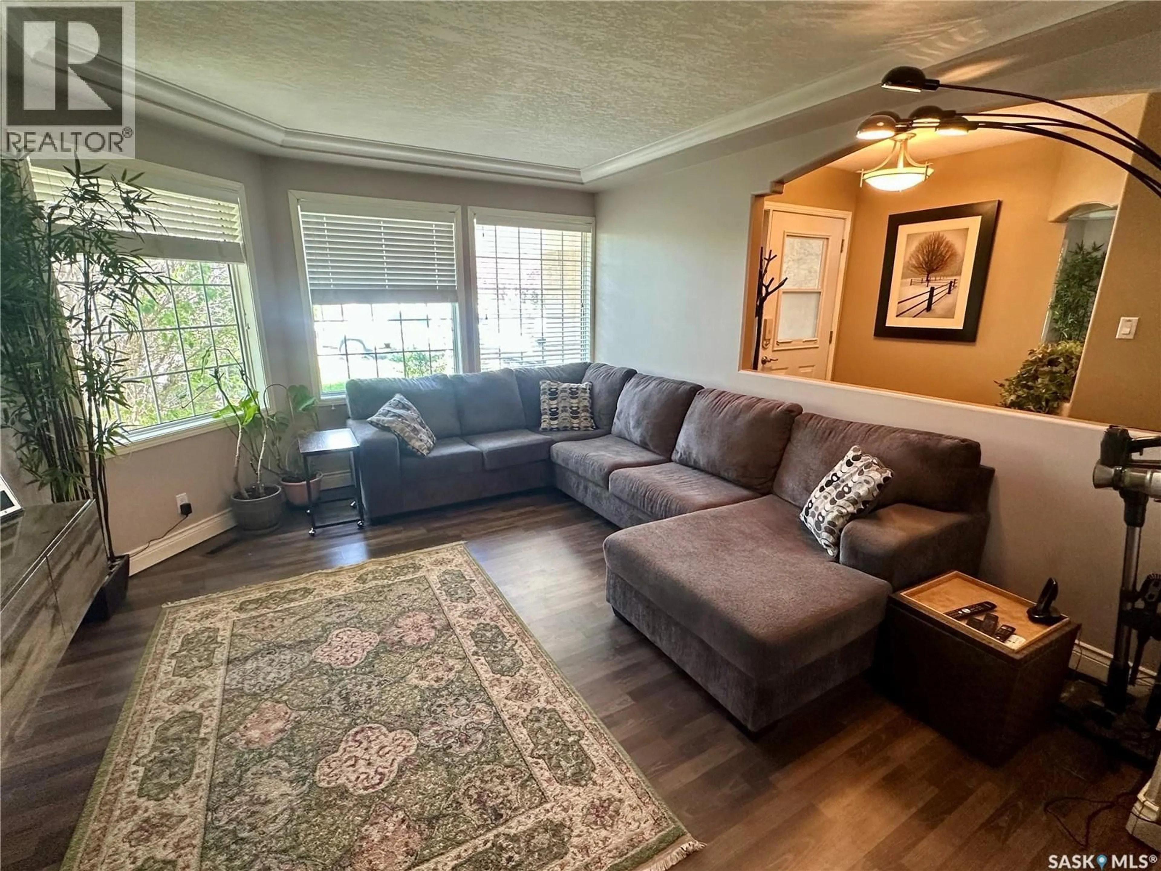 Living room with furniture, wood/laminate floor for 417 4TH AVENUE, Martensville Saskatchewan S0K2T2