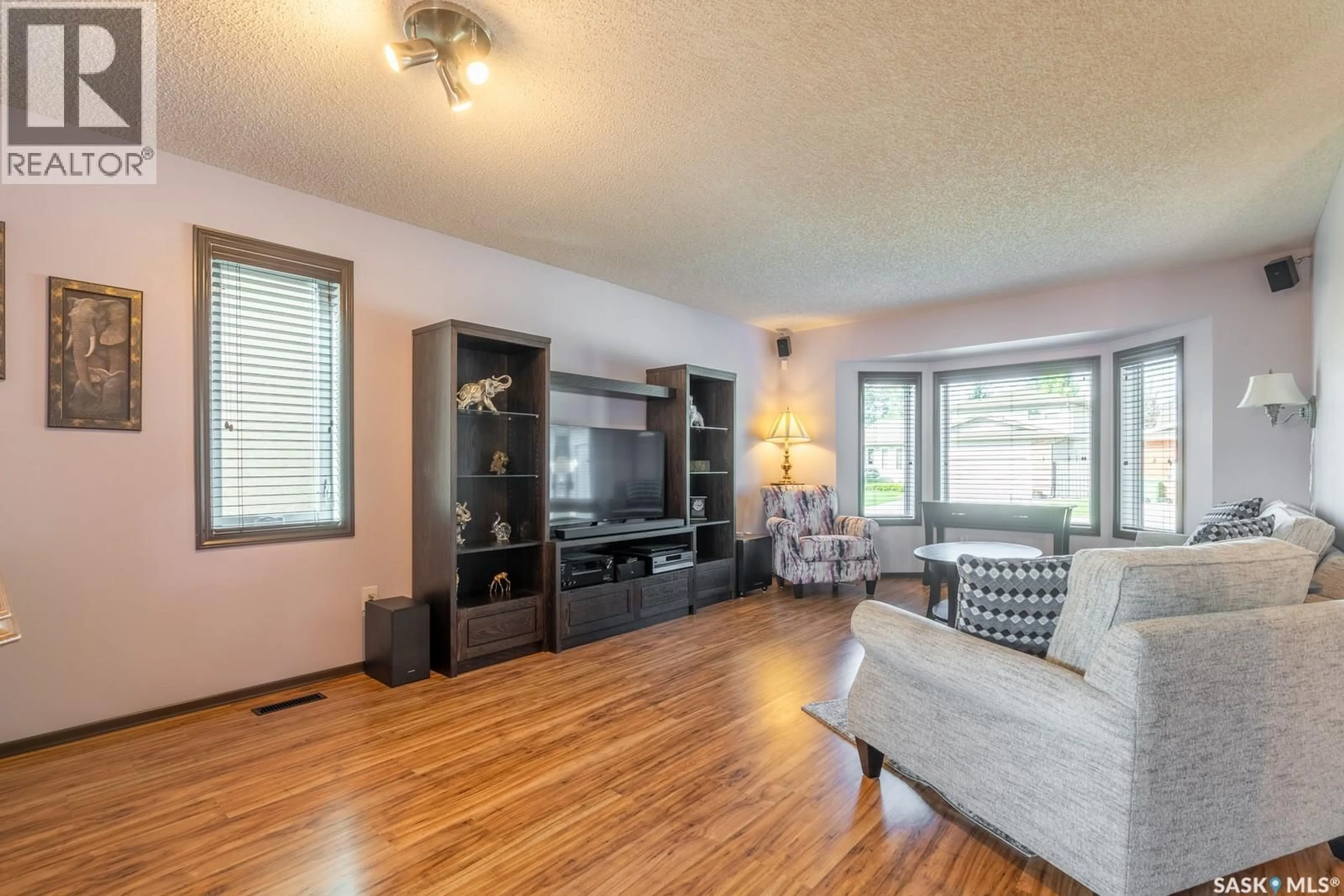 Living room with furniture, wood/laminate floor for 3042 ZARAN CRESCENT, Regina Saskatchewan S4V1Y4