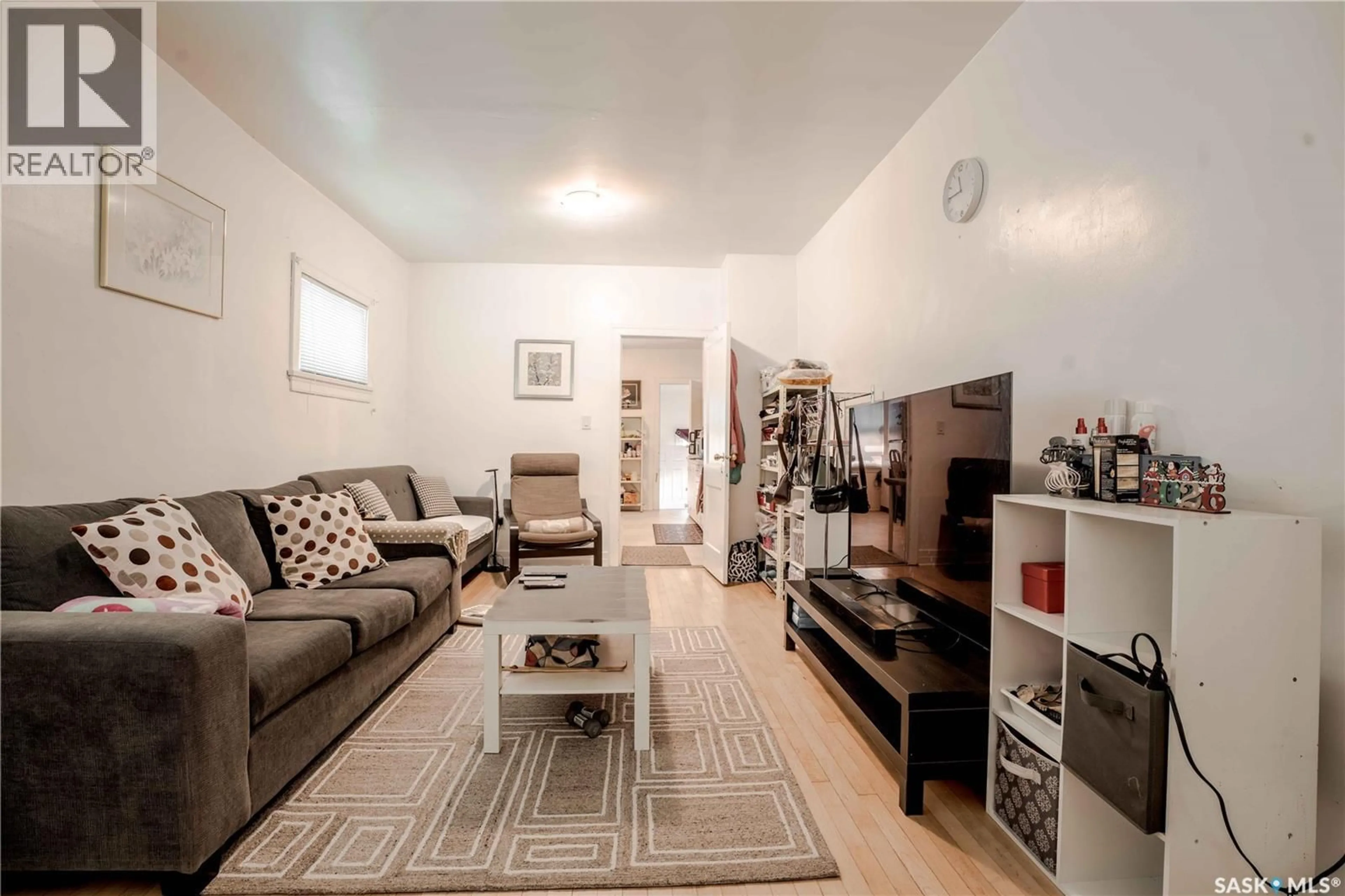 Living room with furniture, wood/laminate floor for 1903 TORONTO STREET, Regina Saskatchewan S4P1M9