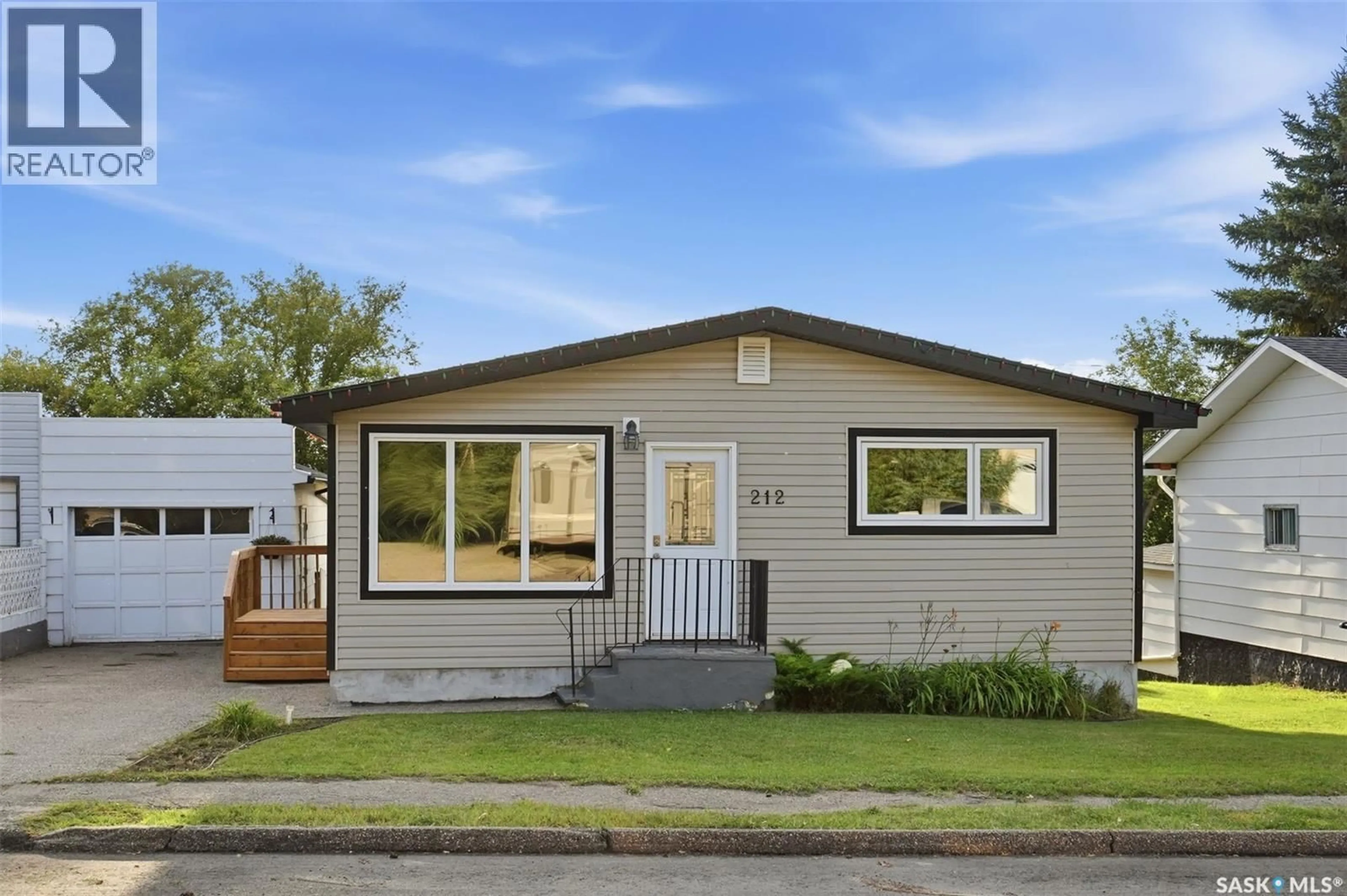 Home with vinyl exterior material, street for 212 3RD STREET, Delisle Saskatchewan S0L0P0