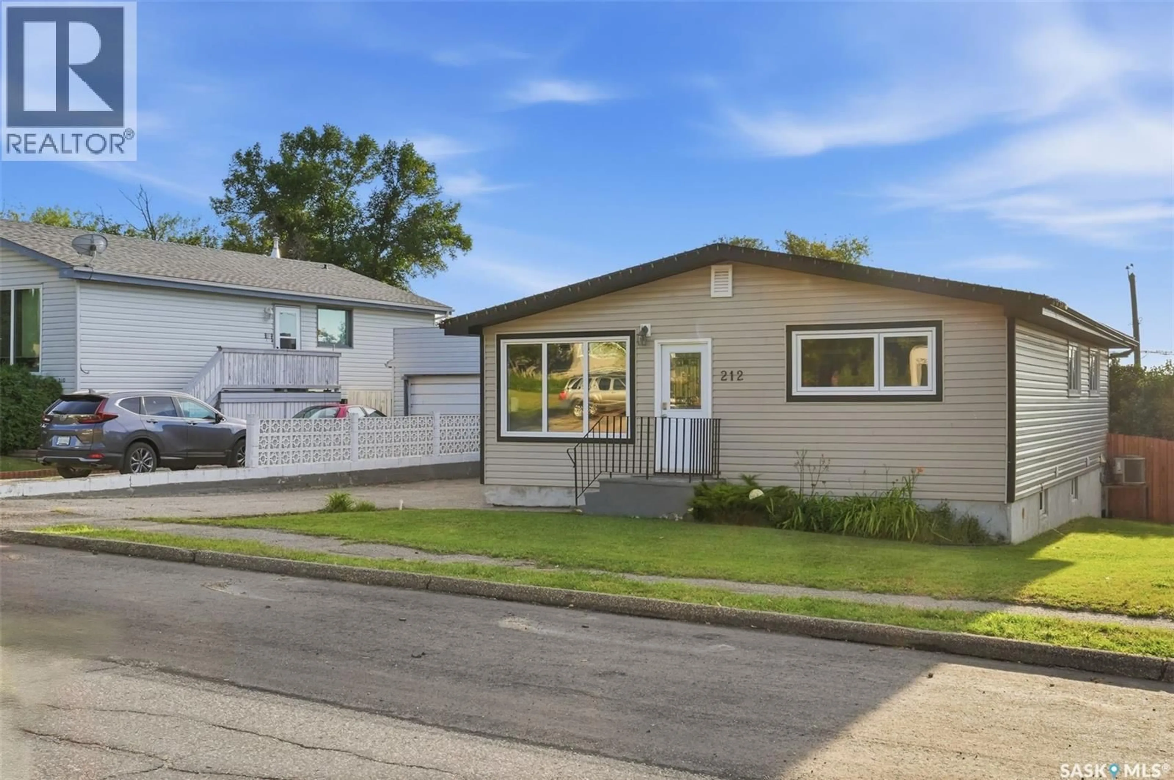 Home with vinyl exterior material, street for 212 3RD STREET, Delisle Saskatchewan S0L0P0