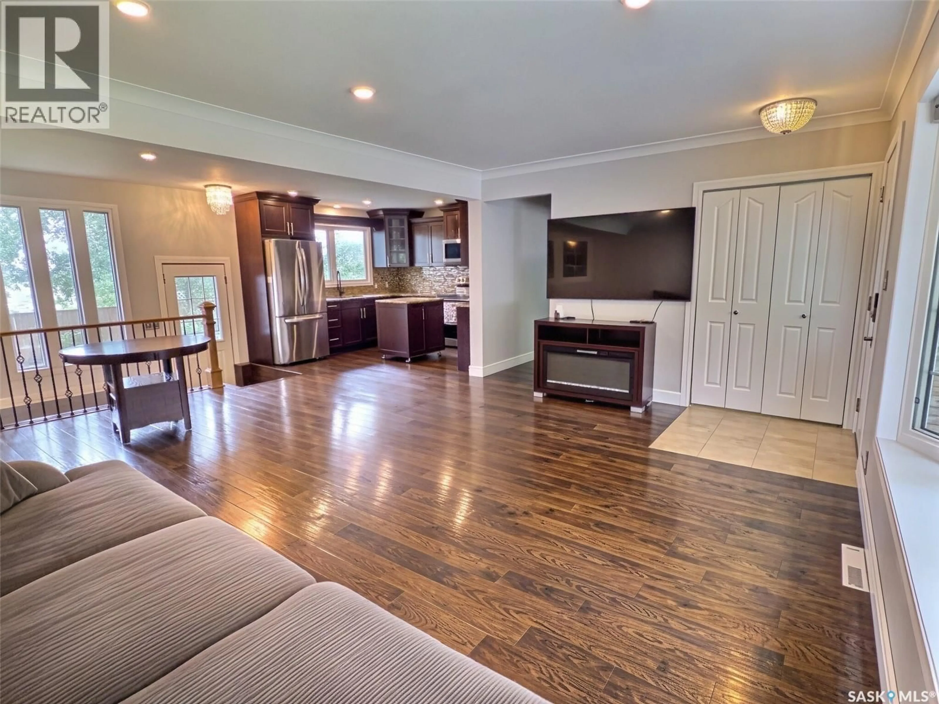 Living room with furniture, wood/laminate floor for 144 MCDONALD ROAD, Estevan Saskatchewan S4A0B8