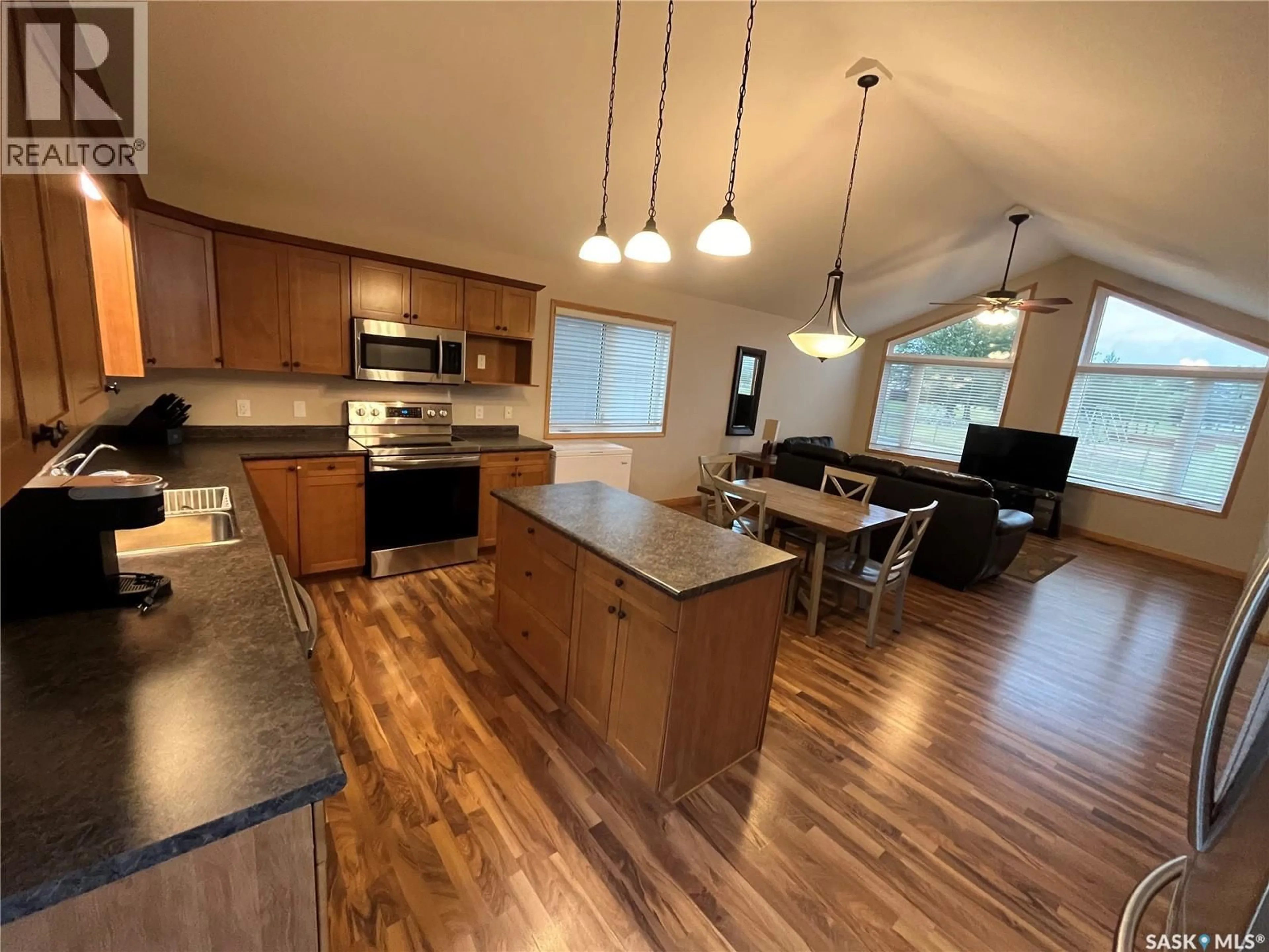 Open concept kitchen, wood/laminate floor for 713 ST MARY STREET, Esterhazy Saskatchewan S0A0X0