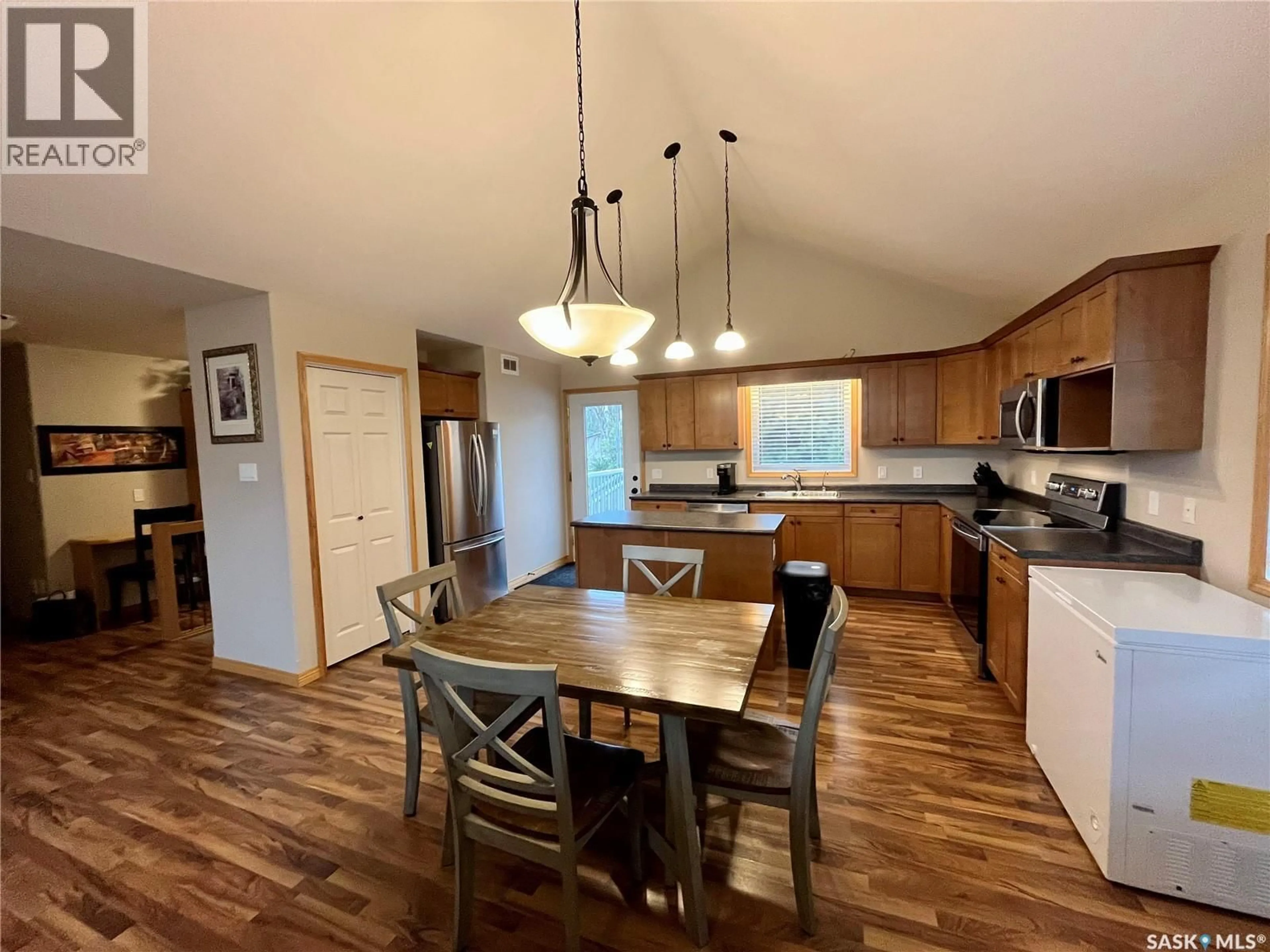 Open concept kitchen, wood/laminate floor for 713 ST MARY STREET, Esterhazy Saskatchewan S0A0X0