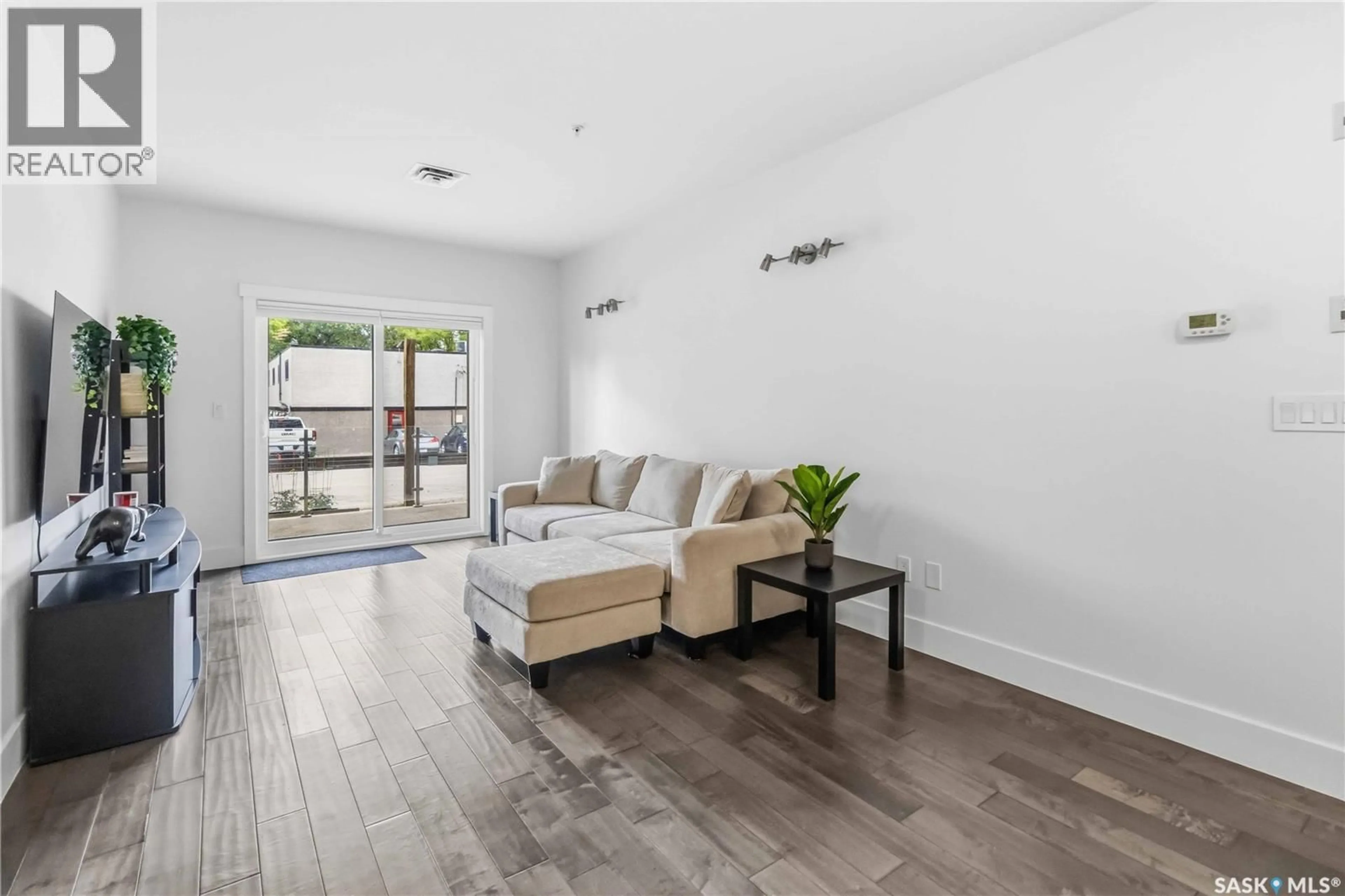Living room with furniture, wood/laminate floor for 104 - 1010 MAIN STREET, Saskatoon Saskatchewan S7H0K7