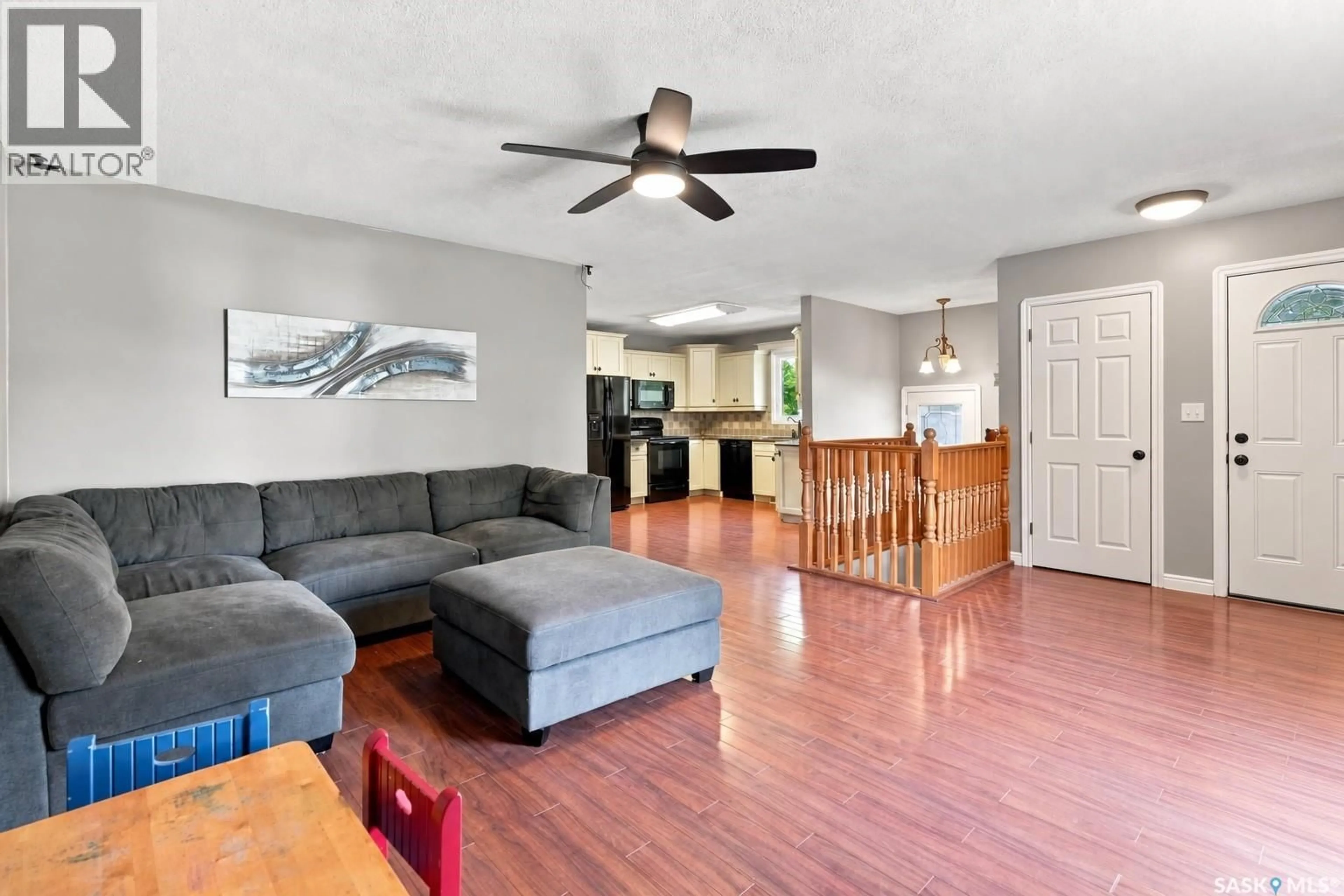 Living room with furniture, wood/laminate floor for 46 COOPER CRESCENT, Regina Saskatchewan S4R4J7
