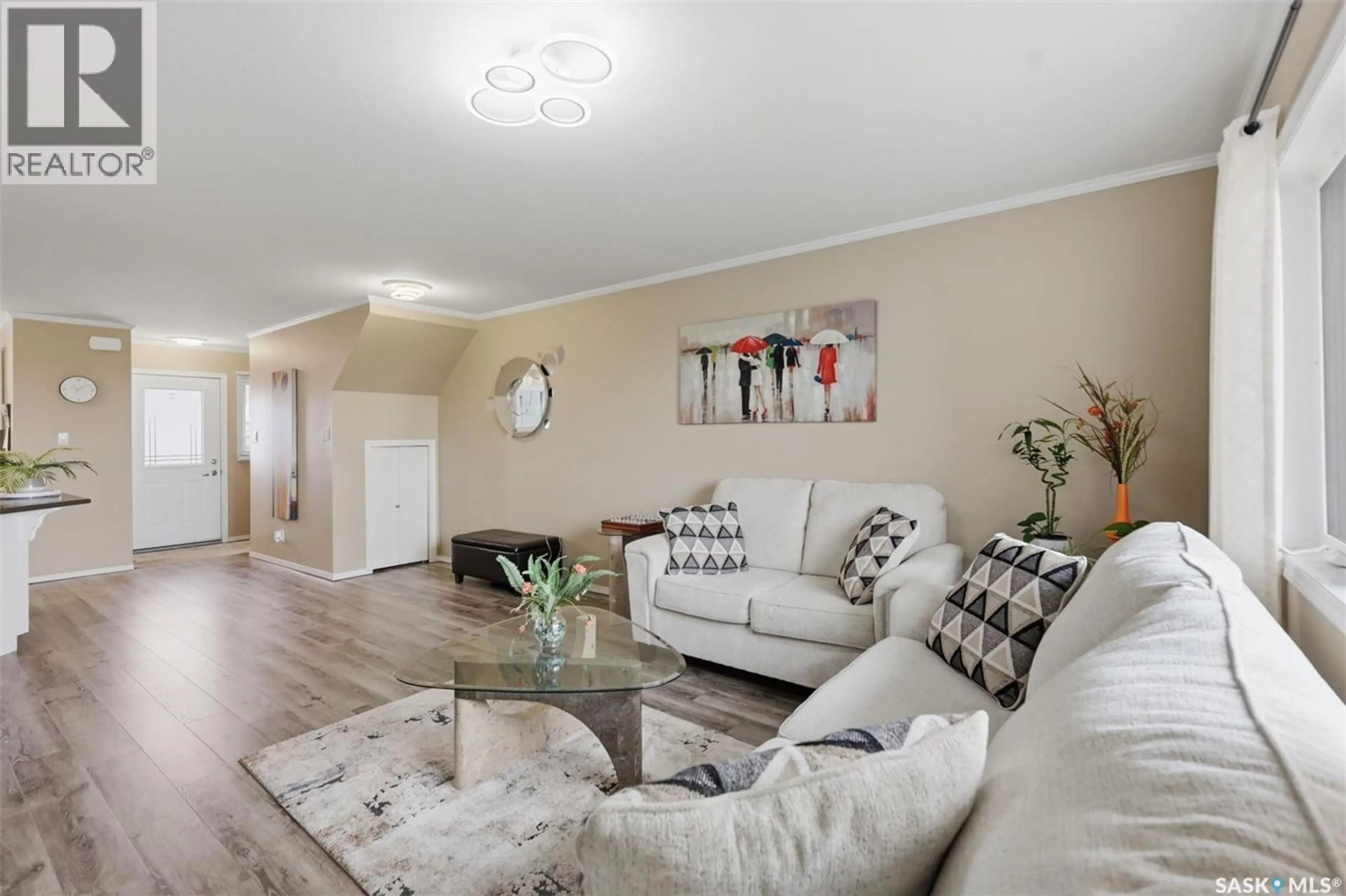 Living room with furniture, wood/laminate floor for 406 - 1303 RICHARDSON ROAD, Saskatoon Saskatchewan S7L0L1