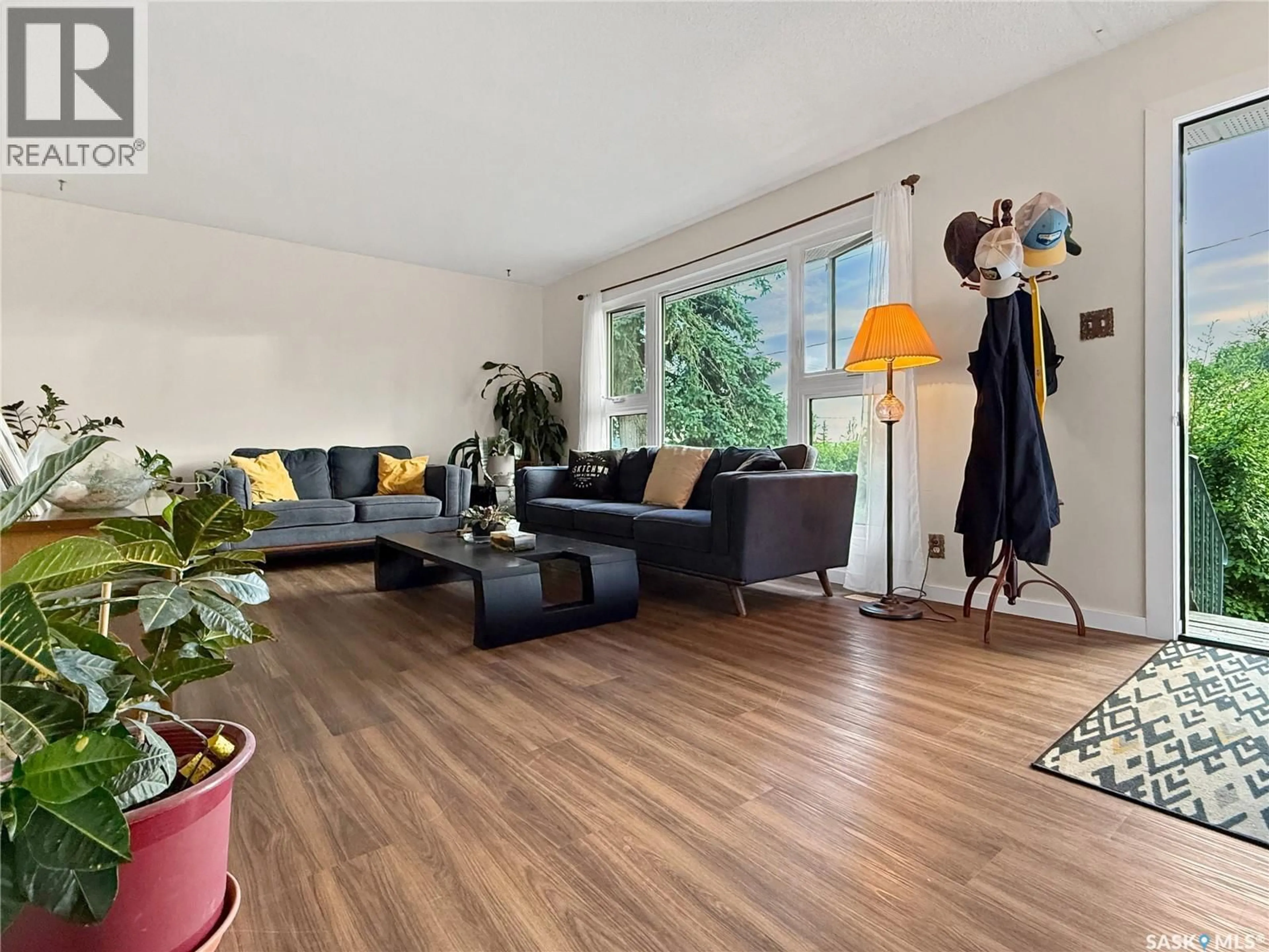 Living room with furniture, wood/laminate floor for 33 7TH AVENUE, Swift Current Saskatchewan S9H2N2