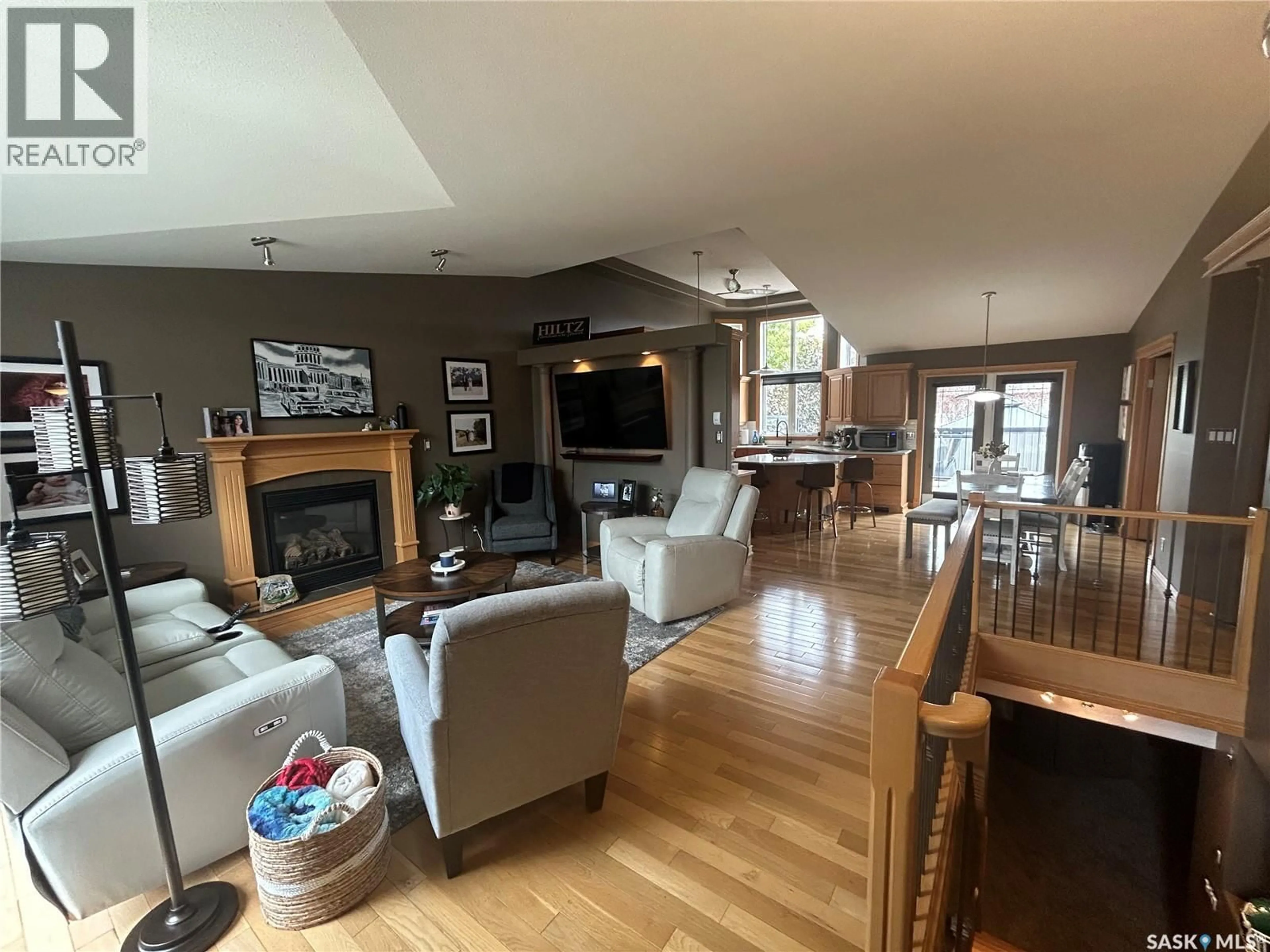 Living room with furniture, wood/laminate floor for 310 BROOKS ROAD, Estevan Saskatchewan S4A2X2