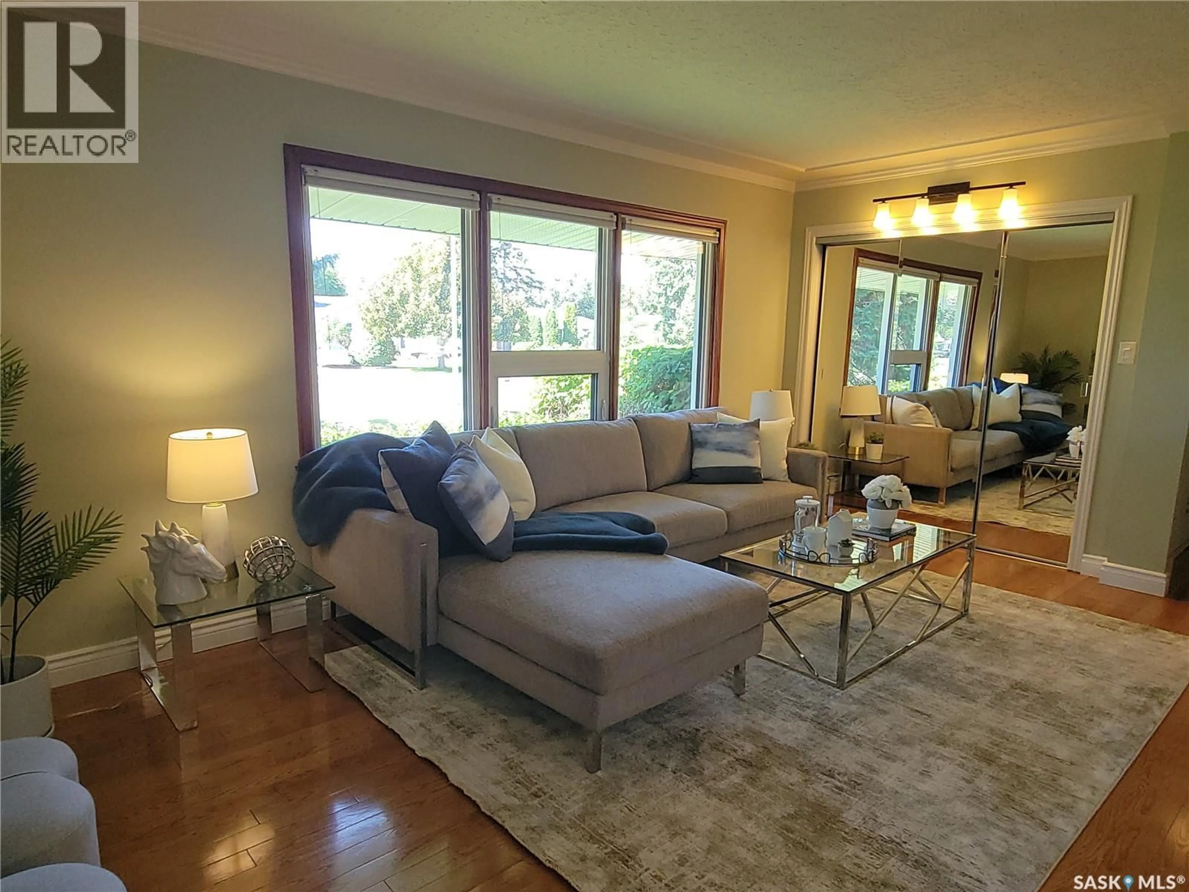 Living room with furniture, wood/laminate floor for 2133 MCKINNON AVENUE, Saskatoon Saskatchewan S7J1N3