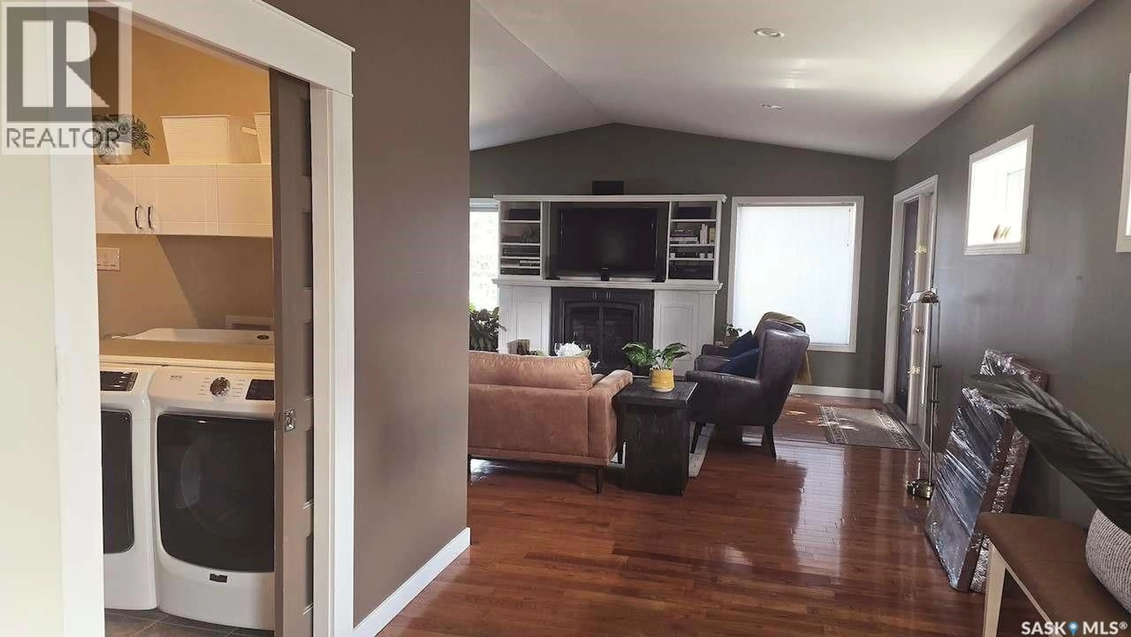Living room with furniture, wood/laminate floor for 2133 MCKINNON AVENUE, Saskatoon Saskatchewan S7J1N3