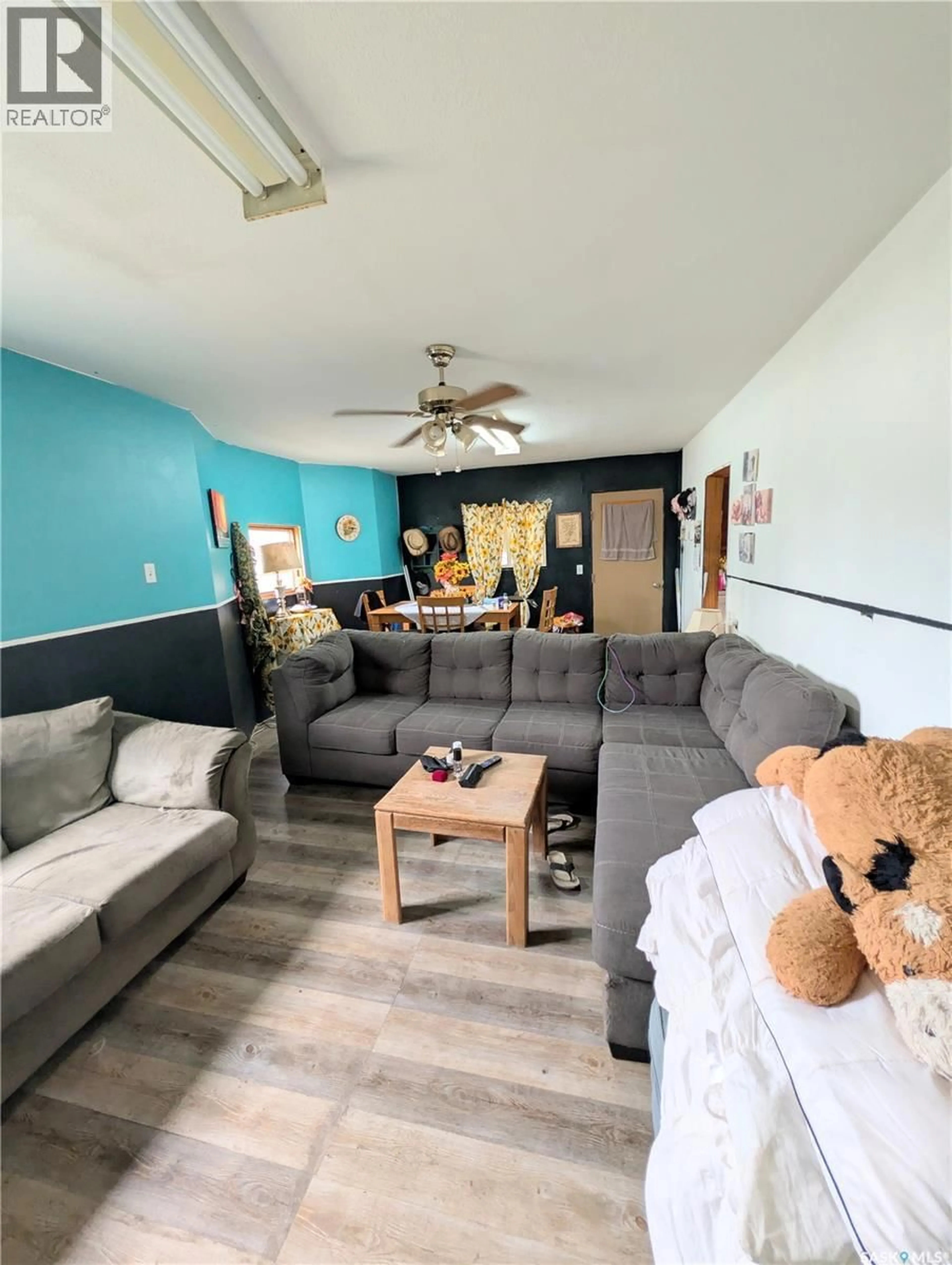 Living room with furniture, wood/laminate floor for 439 4TH STREET, Shaunavon Saskatchewan S0N2M0