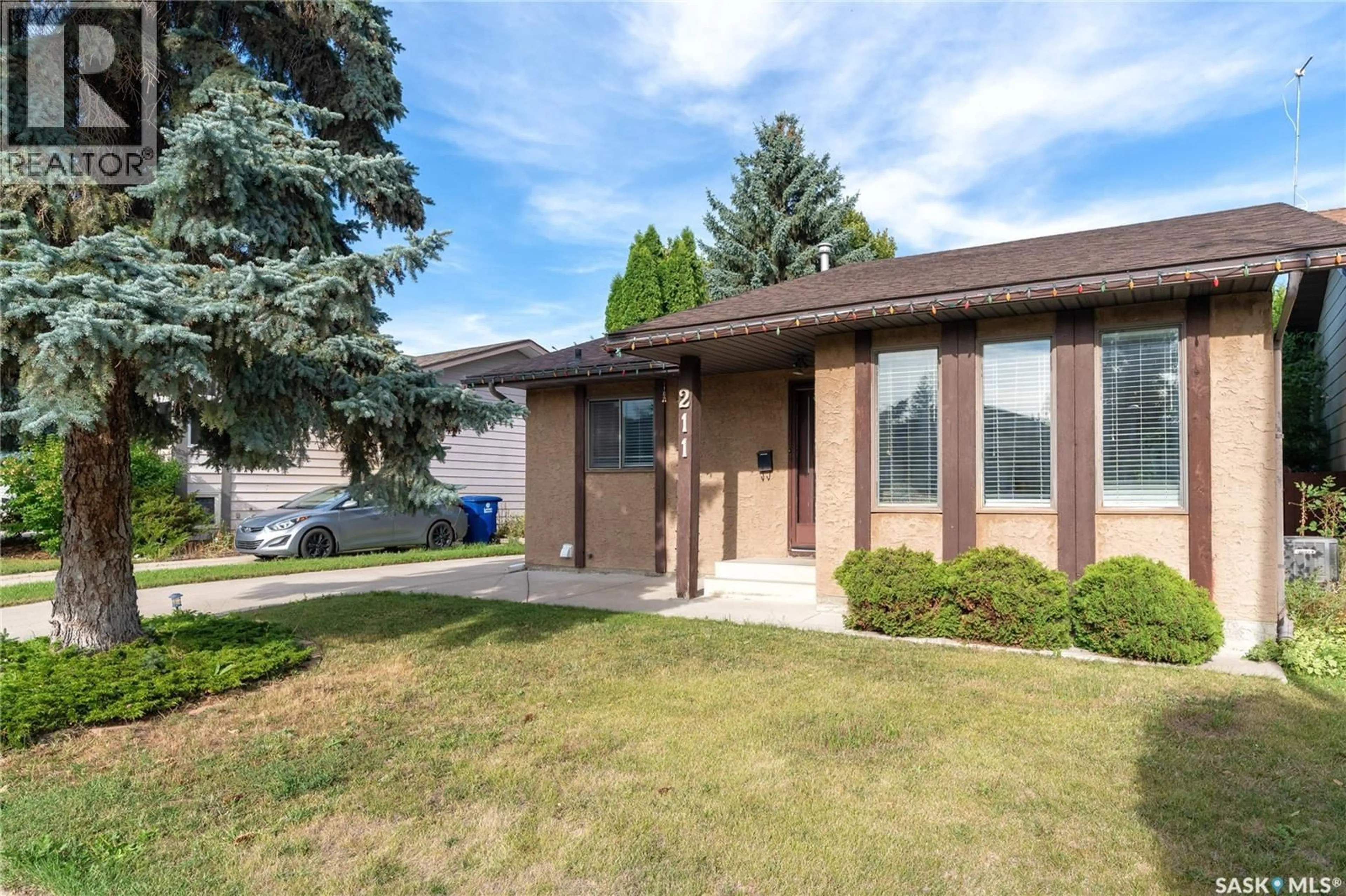 Home with brick exterior material, street for 211 DELARONDE LANE, Saskatoon Saskatchewan S7J3Z1