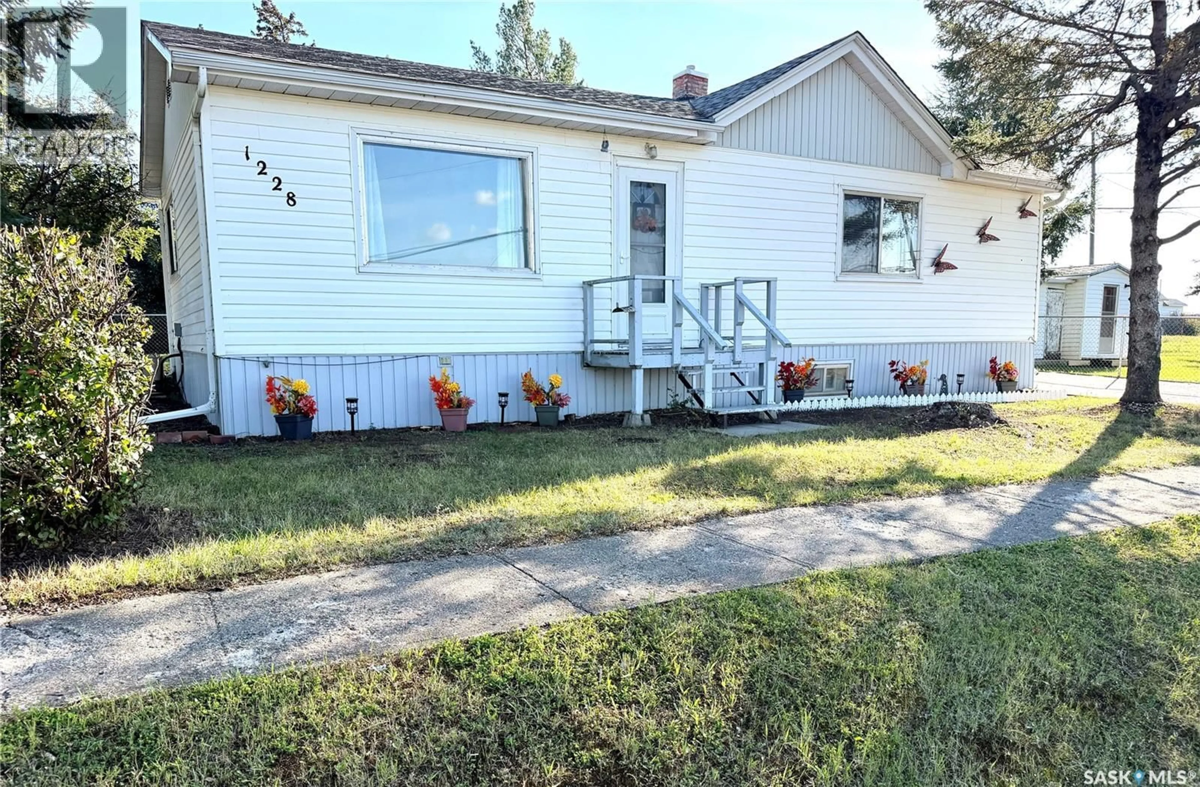Home with vinyl exterior material, street for 1228 TAYLOR STREET, Herbert Saskatchewan S0H2A0