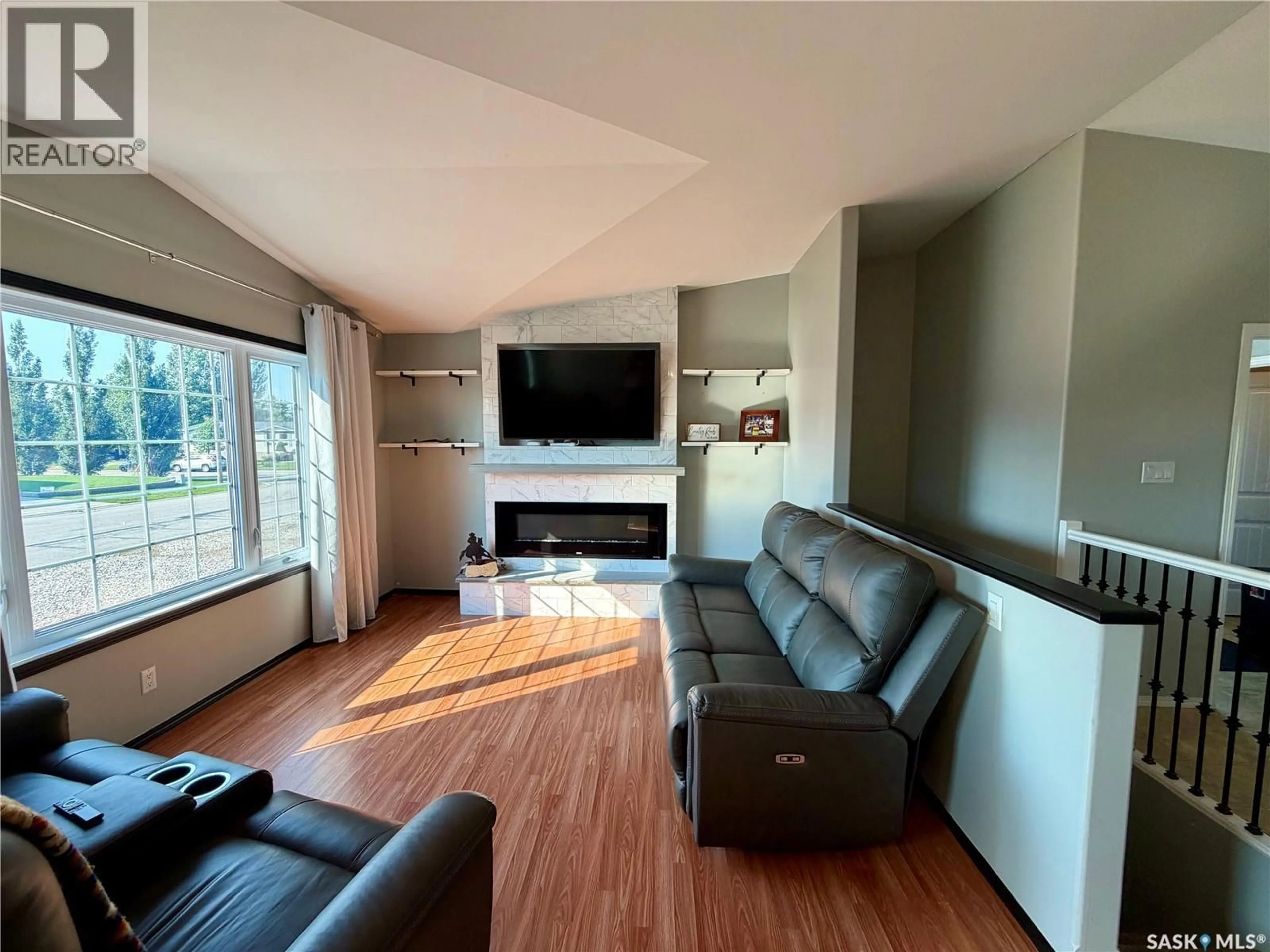 Living room with furniture, wood/laminate floor for 303 5TH STREET, Carnduff Saskatchewan S0C0S0