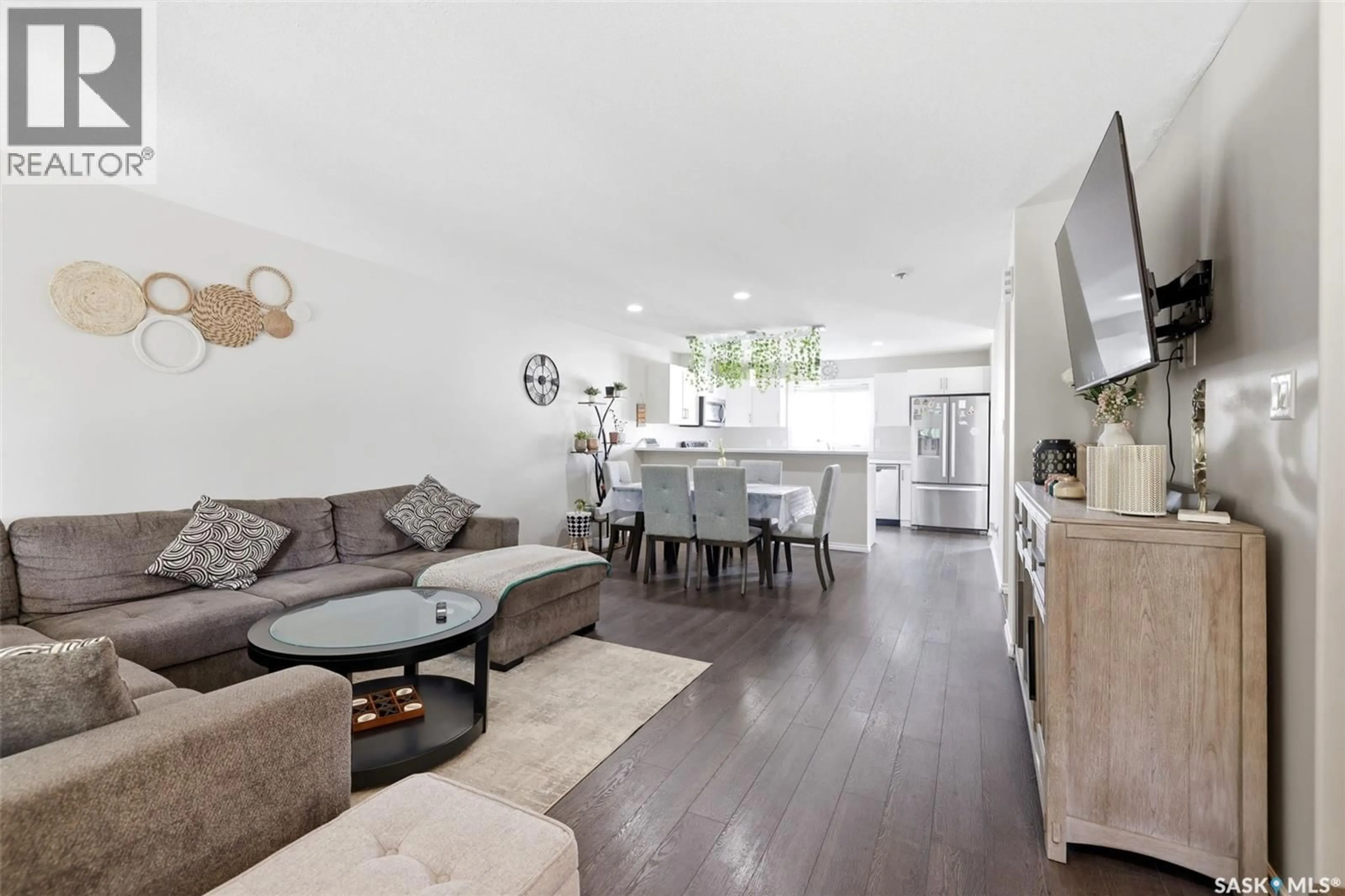 Living room with furniture, wood/laminate floor for 5544 PREFONTAINE AVENUE, Regina Saskatchewan S4W0M8