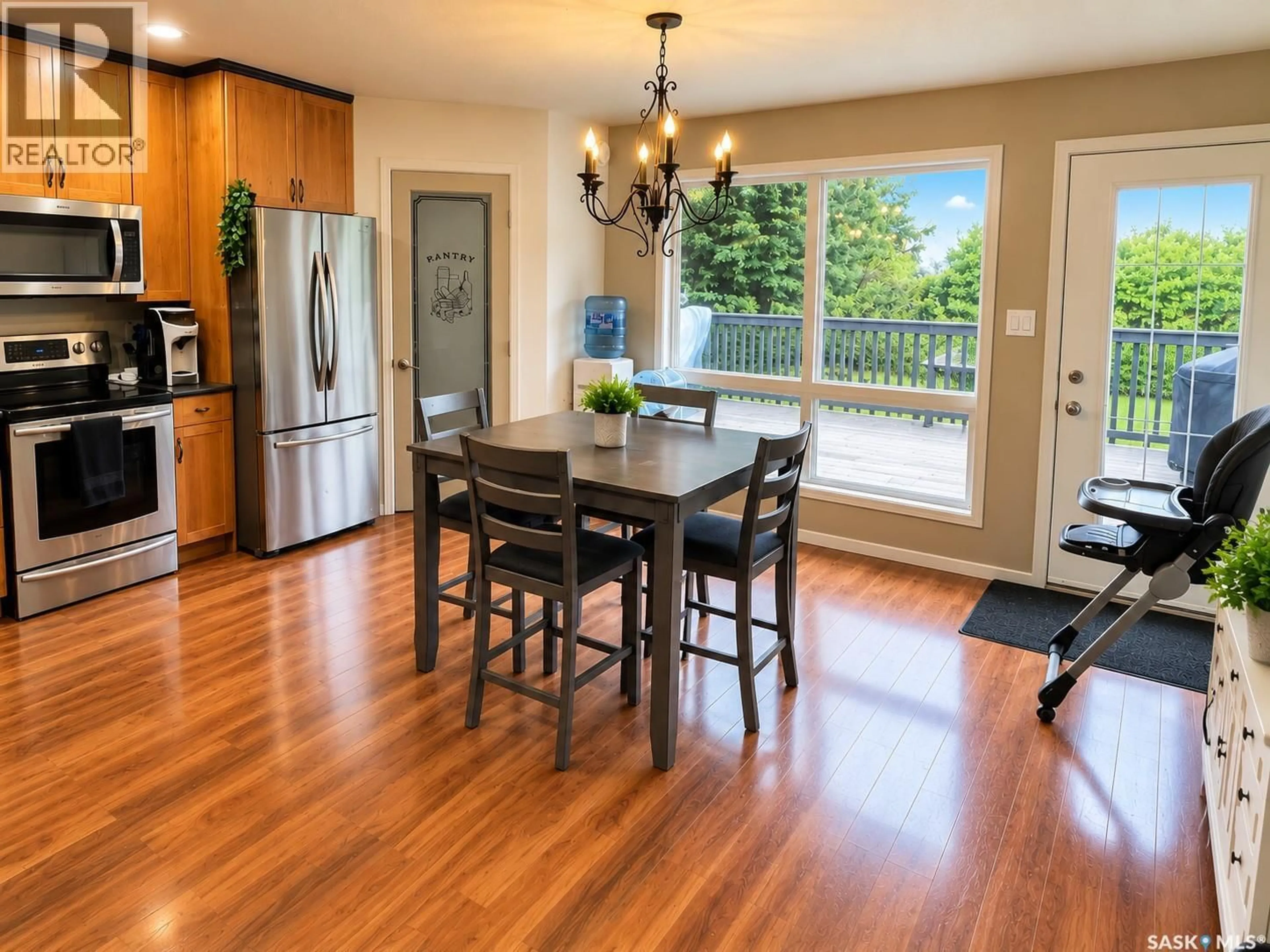 Open concept kitchen, wood/laminate floor for 306 CENTRE AVENUE, Meadow Lake Saskatchewan S9X1H2