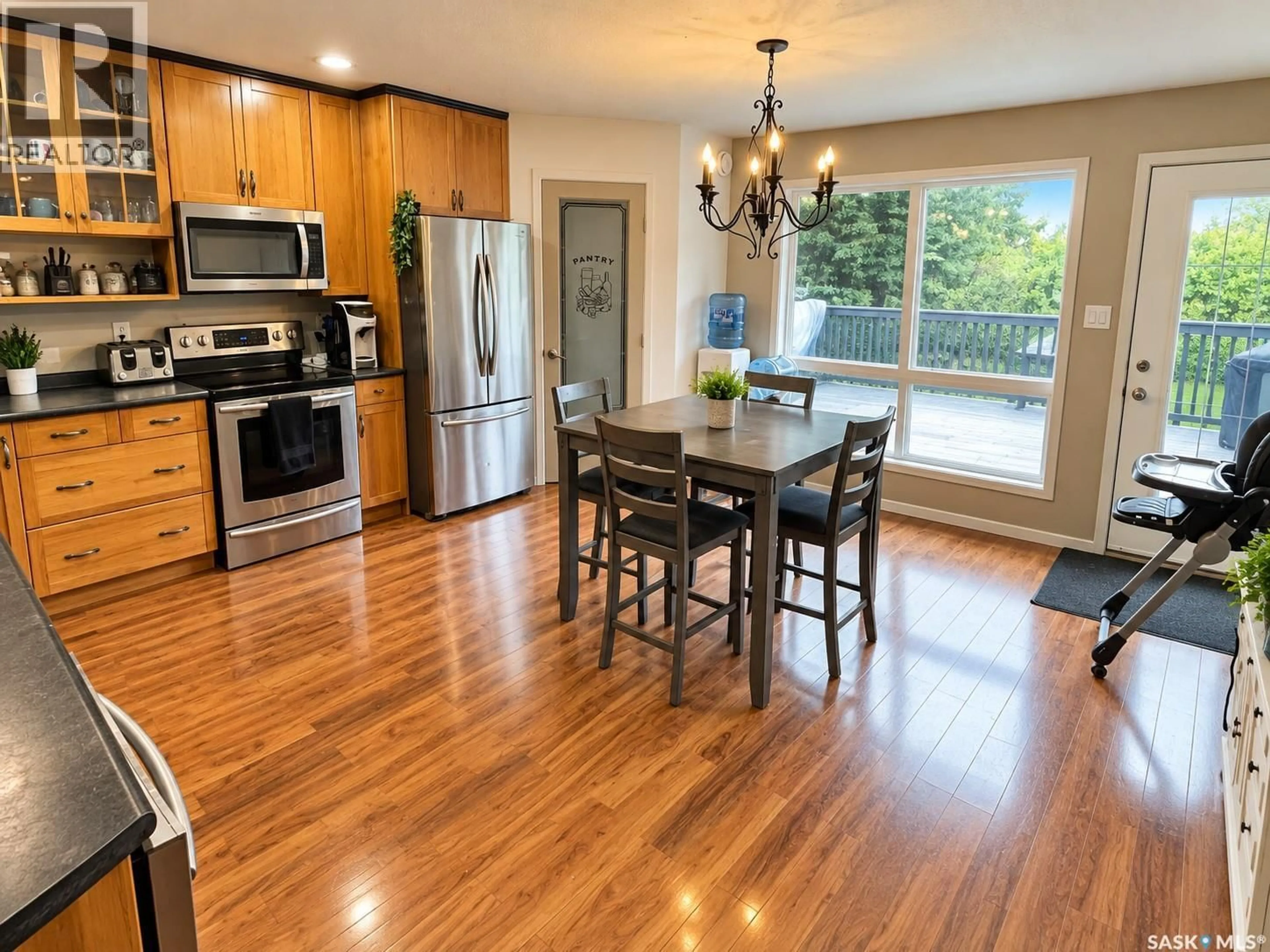 Open concept kitchen, wood/laminate floor for 306 CENTRE AVENUE, Meadow Lake Saskatchewan S9X1H2