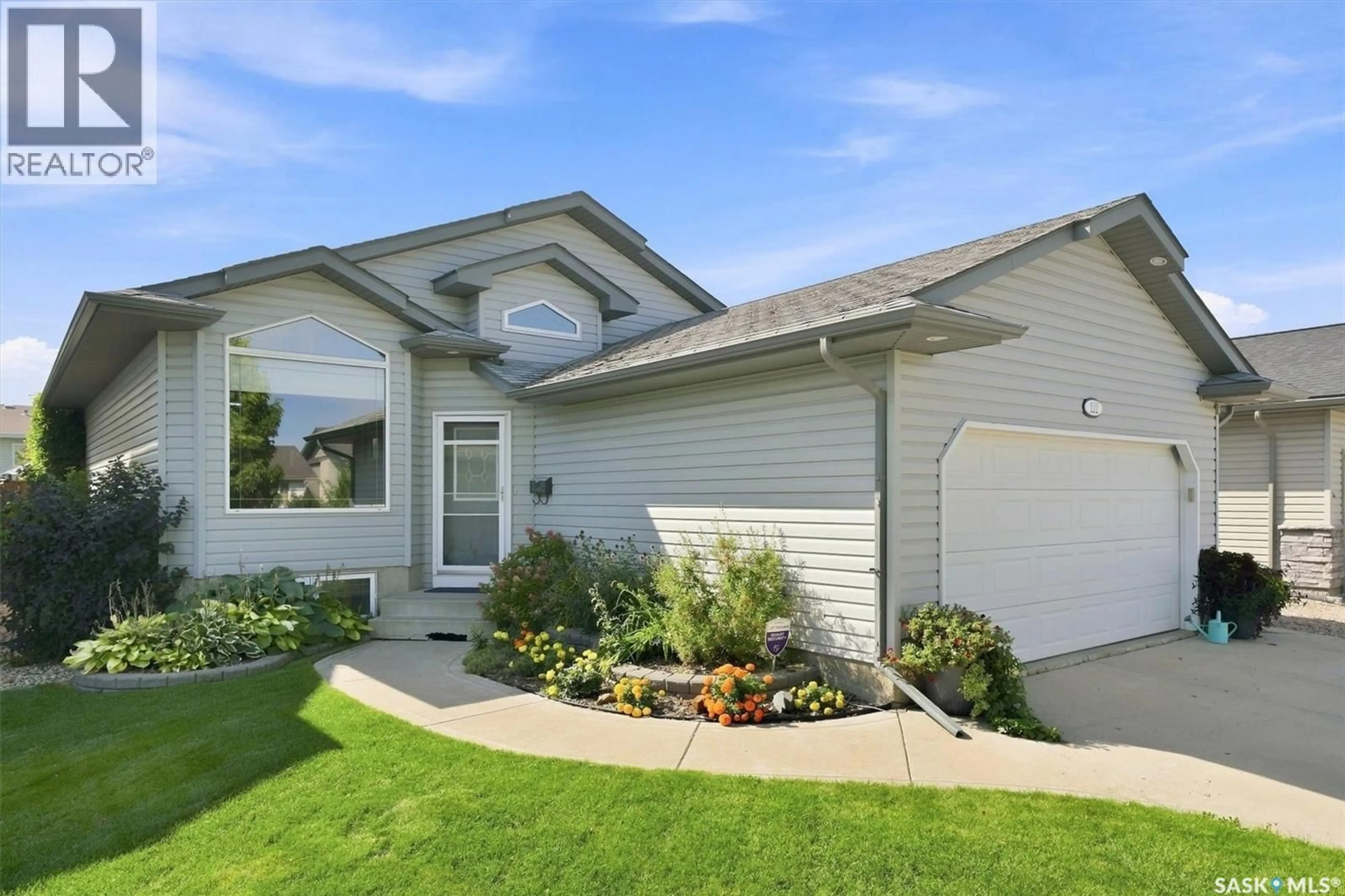 Home with vinyl exterior material, street for 122 OVERHOLT CRESCENT, Saskatoon Saskatchewan S7N4S9