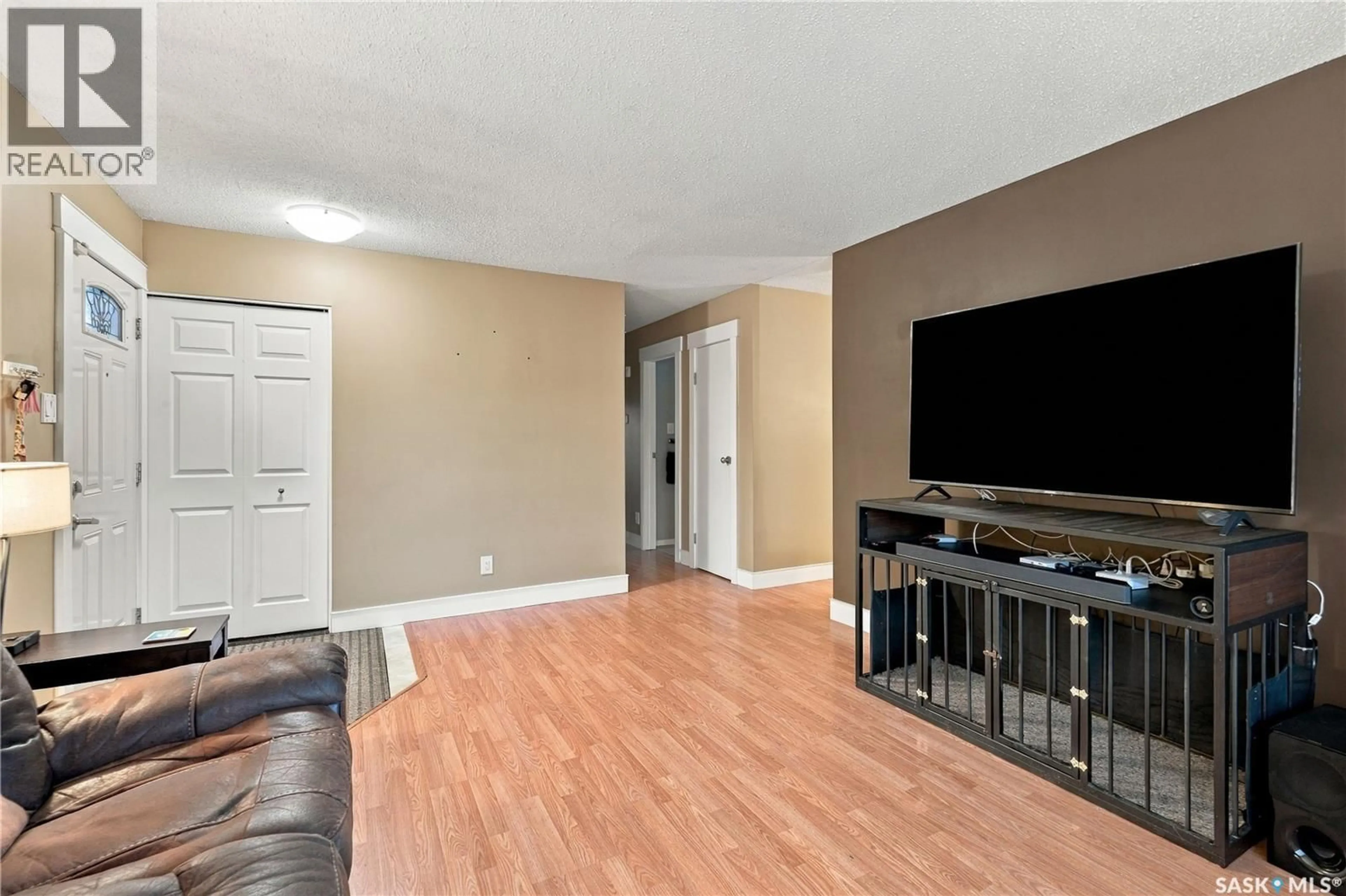 Living room with furniture, wood/laminate floor for 426 LANGEVIN CRESCENT, Saskatoon Saskatchewan S7L5R6