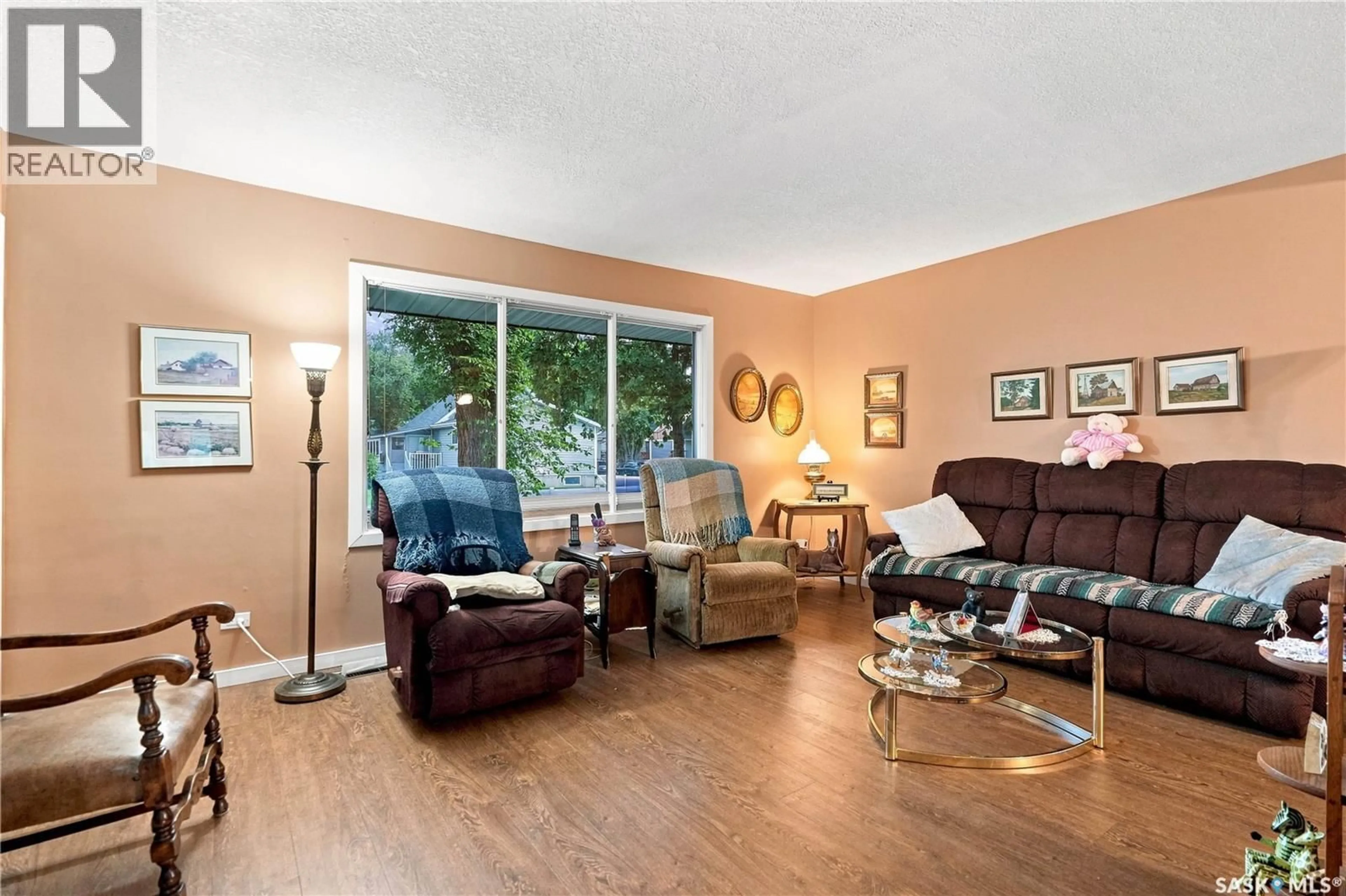 Living room with furniture, wood/laminate floor for 4230 6TH AVENUE, Regina Saskatchewan S4T0N6